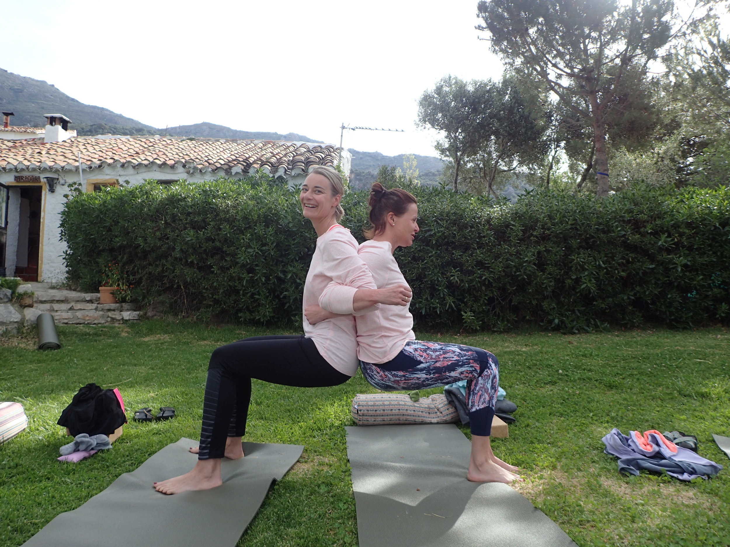 Partner yoga in garden at Yin Yang Yoga retreat in the Malaga mountains in Spain with Jane Bakx Yoga