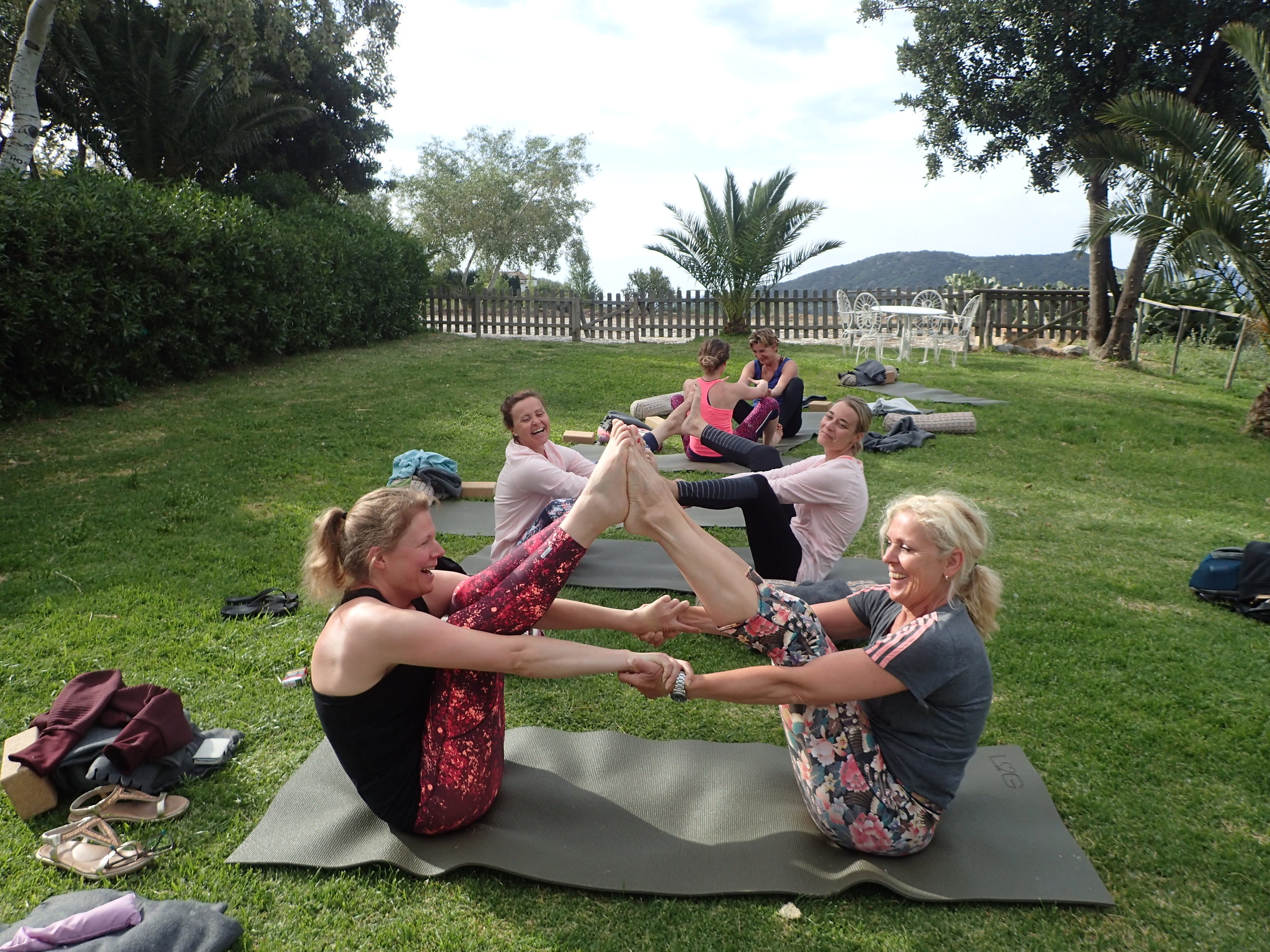 Partner yoga in the garden at Yin Yang Yoga retreat in the Malaga mountains in Spain with Jane Bakx Yoga