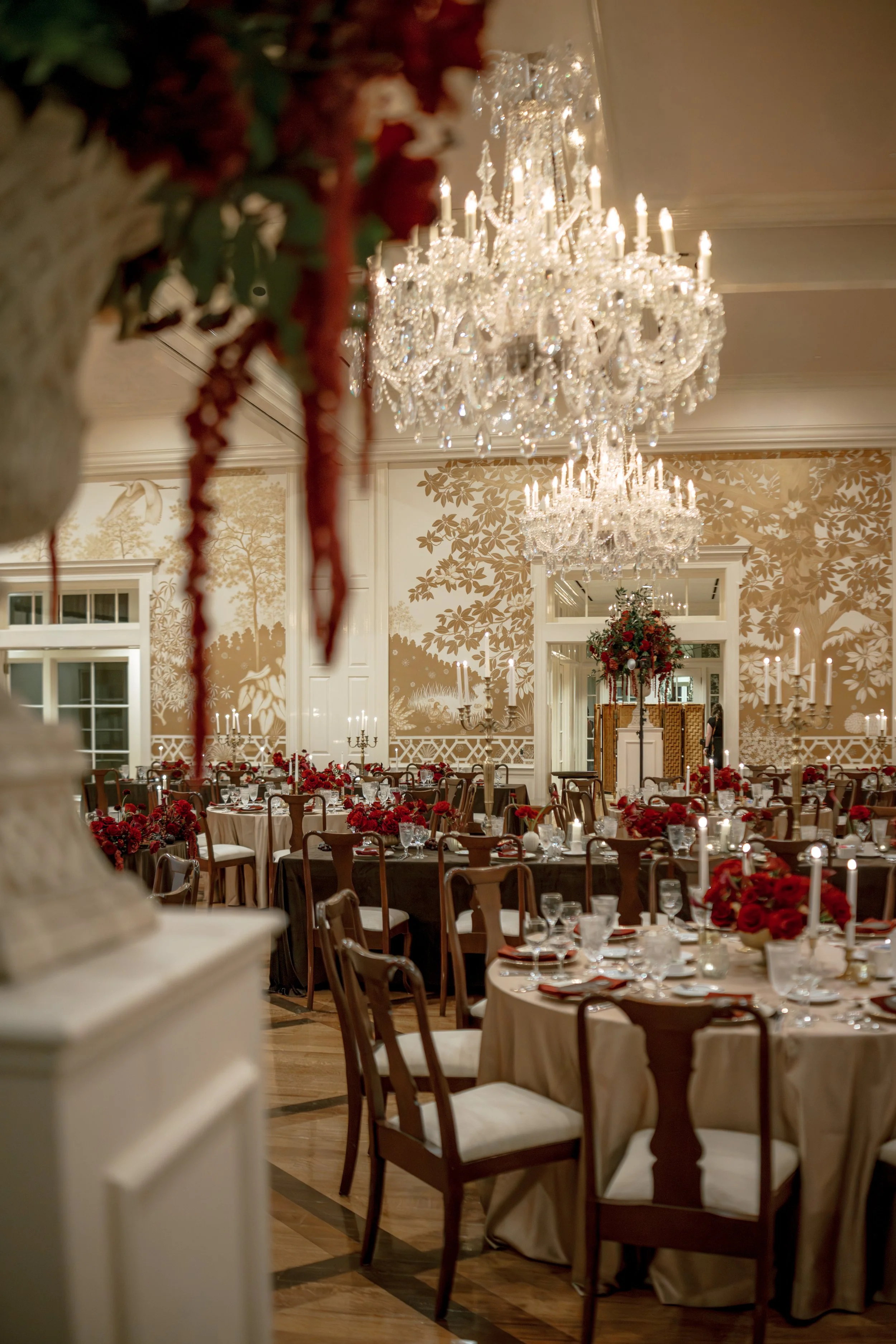 Luxury red rose wedding reception with low floral centerpieces at Junior League of Houston.