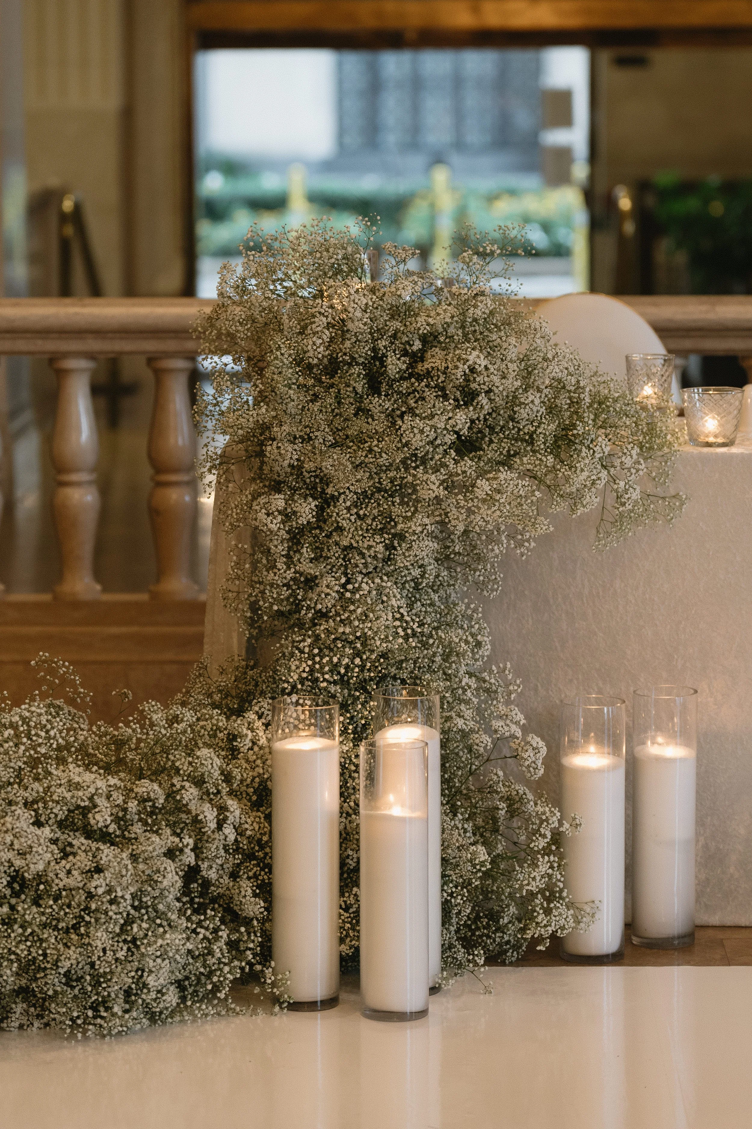 Lush baby's breath sweetheart table floral at The Corinthian Houston wedding reception