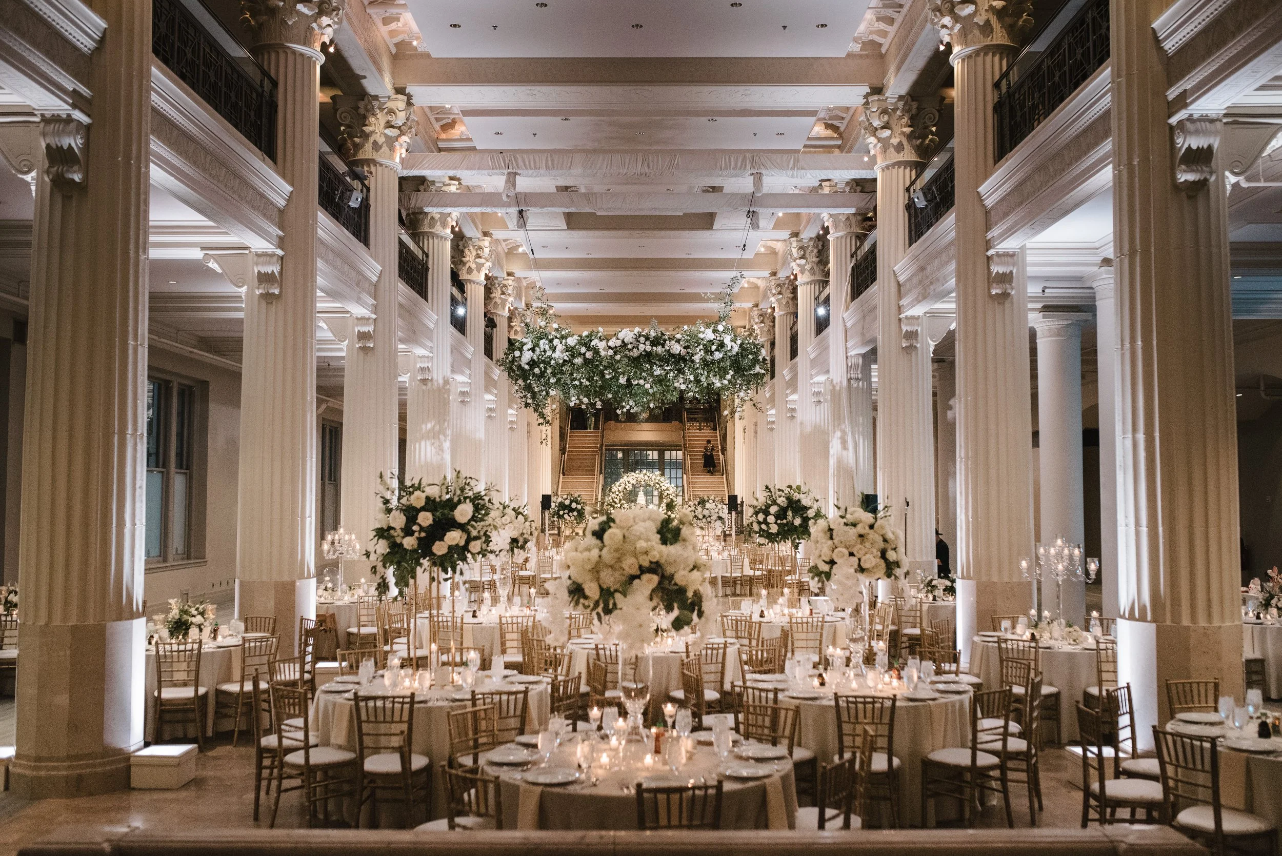 Lush floral chandelier and candlelit candelabras transformed The Corinthian Houston's ballroom into a breathtaking reception space.