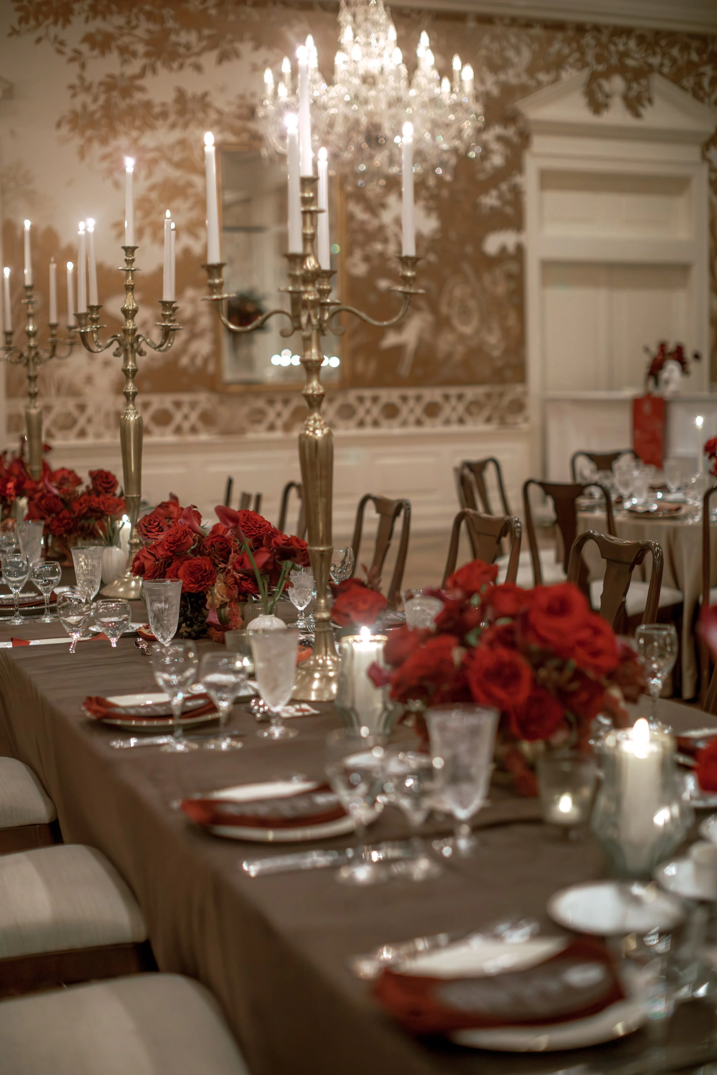 Luxury red rose wedding reception with low floral centerpieces at Junior League of Houston.