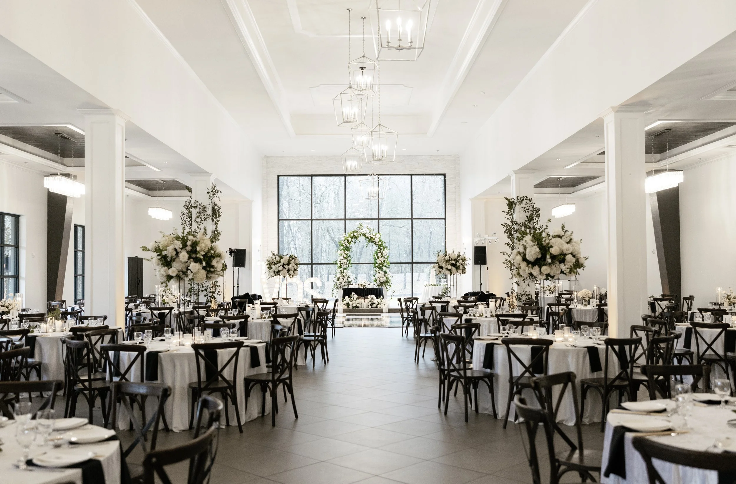 Houston luxury wedding florist designing sophisticated floral arrangements at Luminaire venue with timeless romantic styling.