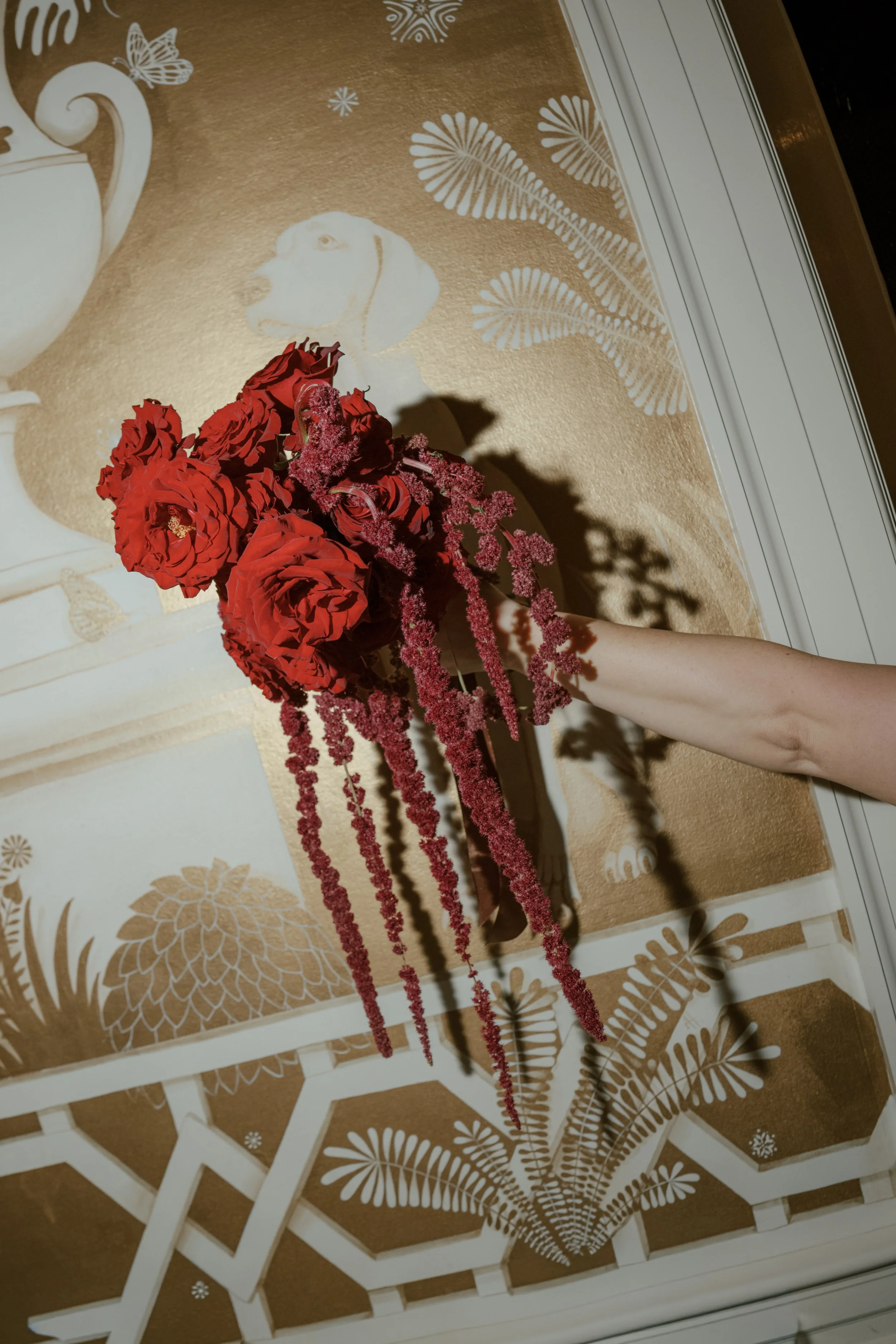 Luxury red rose and cascading amaranthus bridal bouquet at Junior League of Houston wedding.