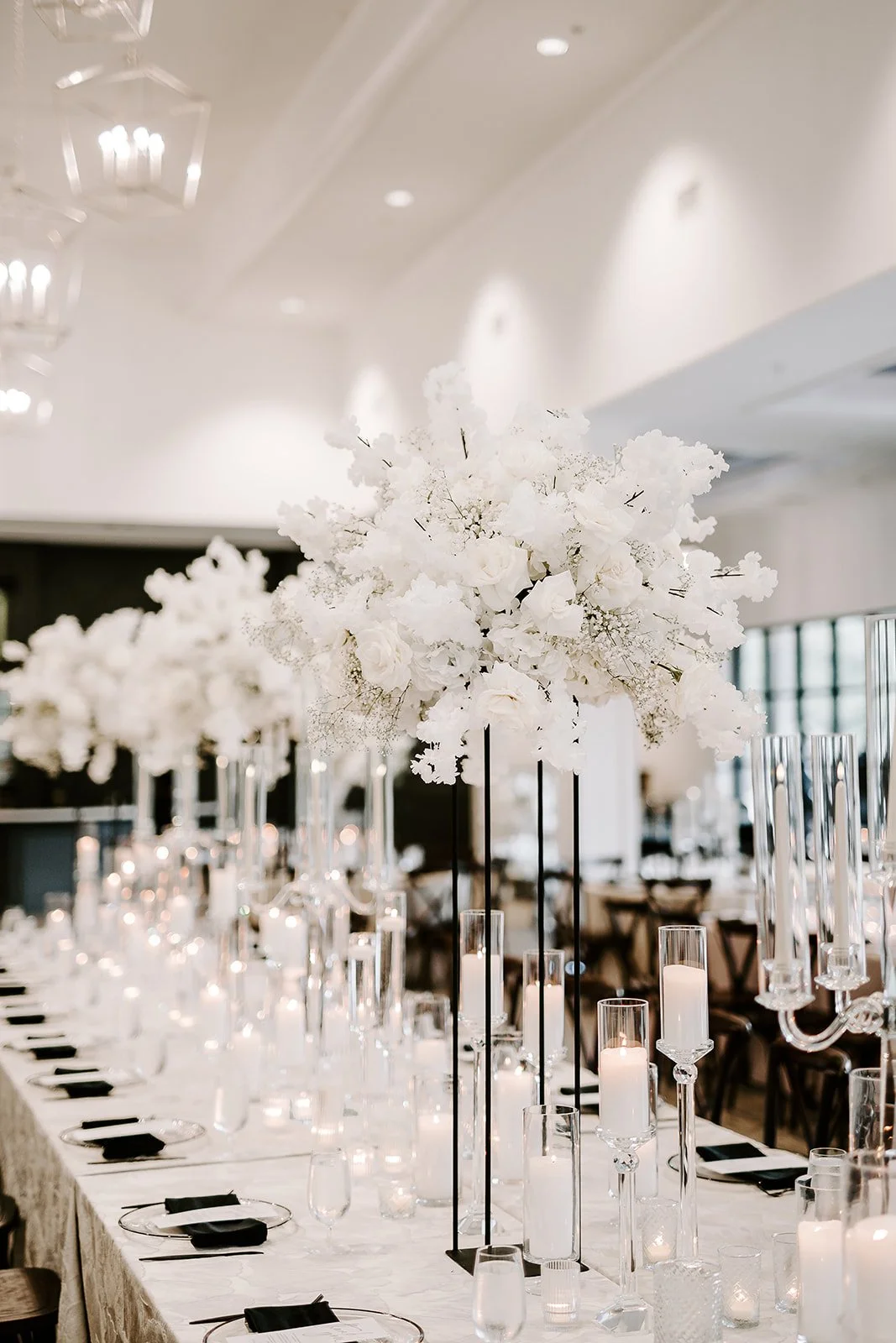 Houston luxury wedding florist designing sophisticated floral arrangements at Luminaire venue with timeless romantic styling.