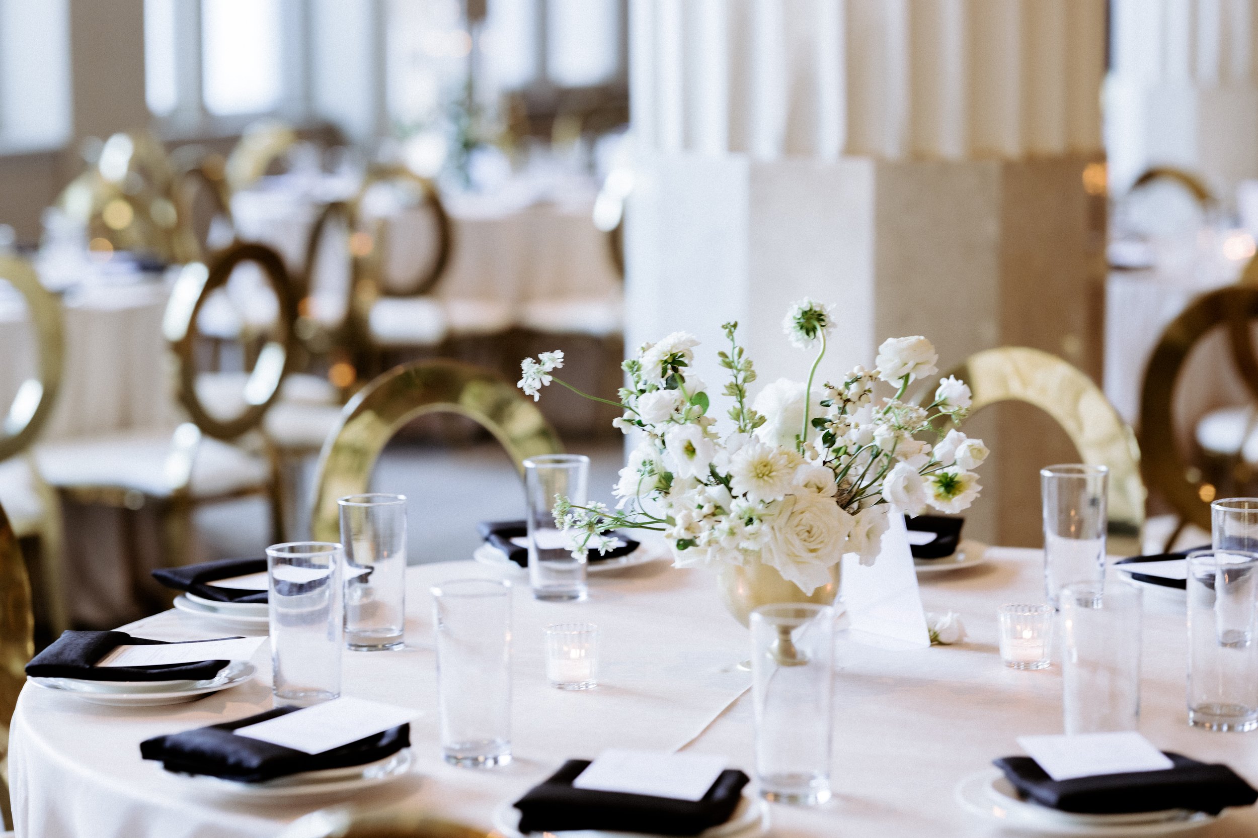 Modern low floral centerpieces at The Corinthian Houston luxury wedding reception round tables.