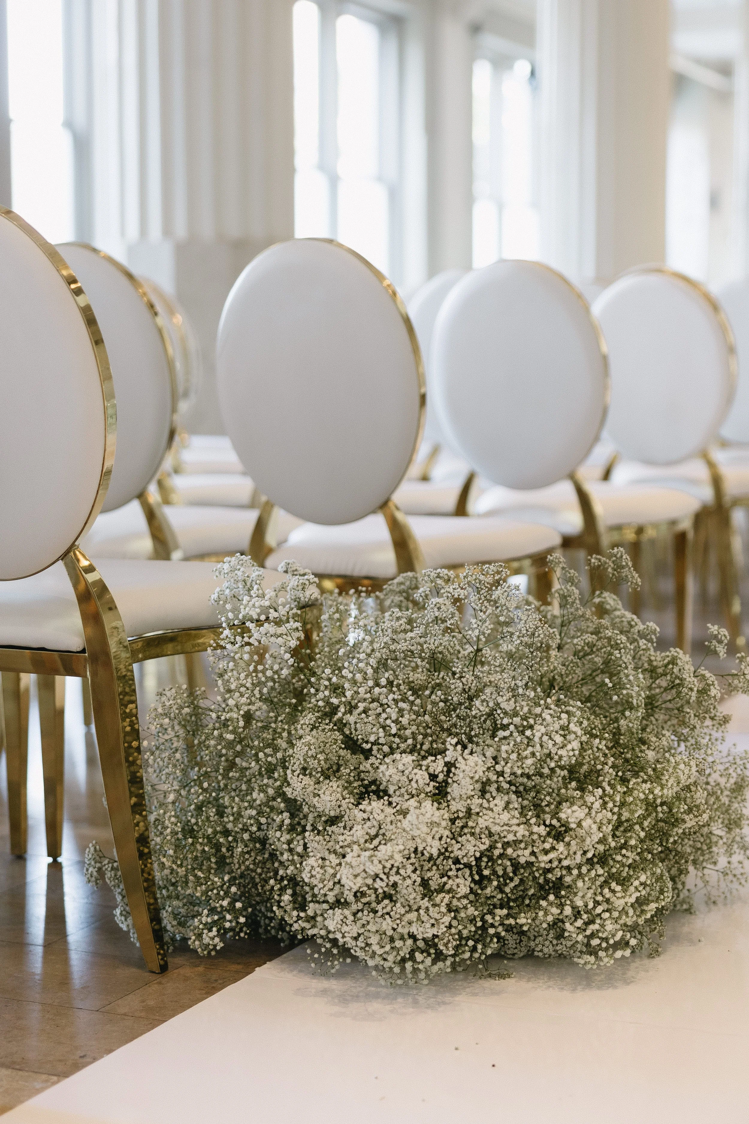 Lush baby's breath ceremony meadow installation at The Corinthian Houston wedding