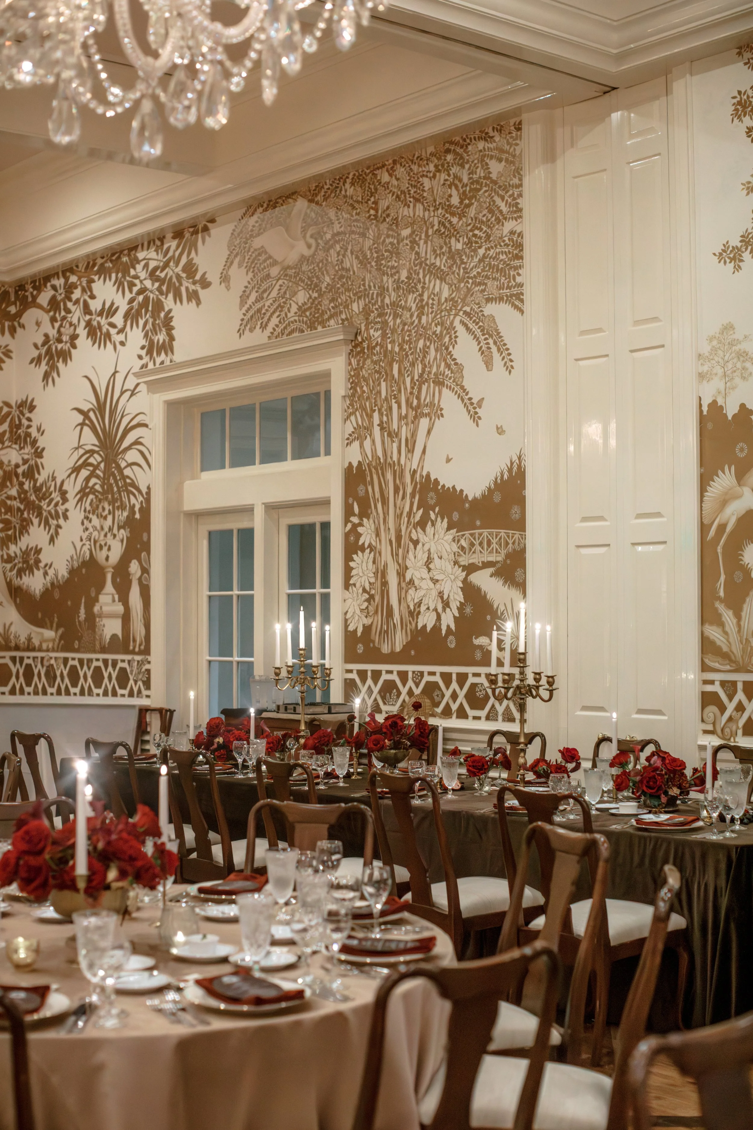 Luxury red rose wedding reception with low floral centerpieces at Junior League of Houston.