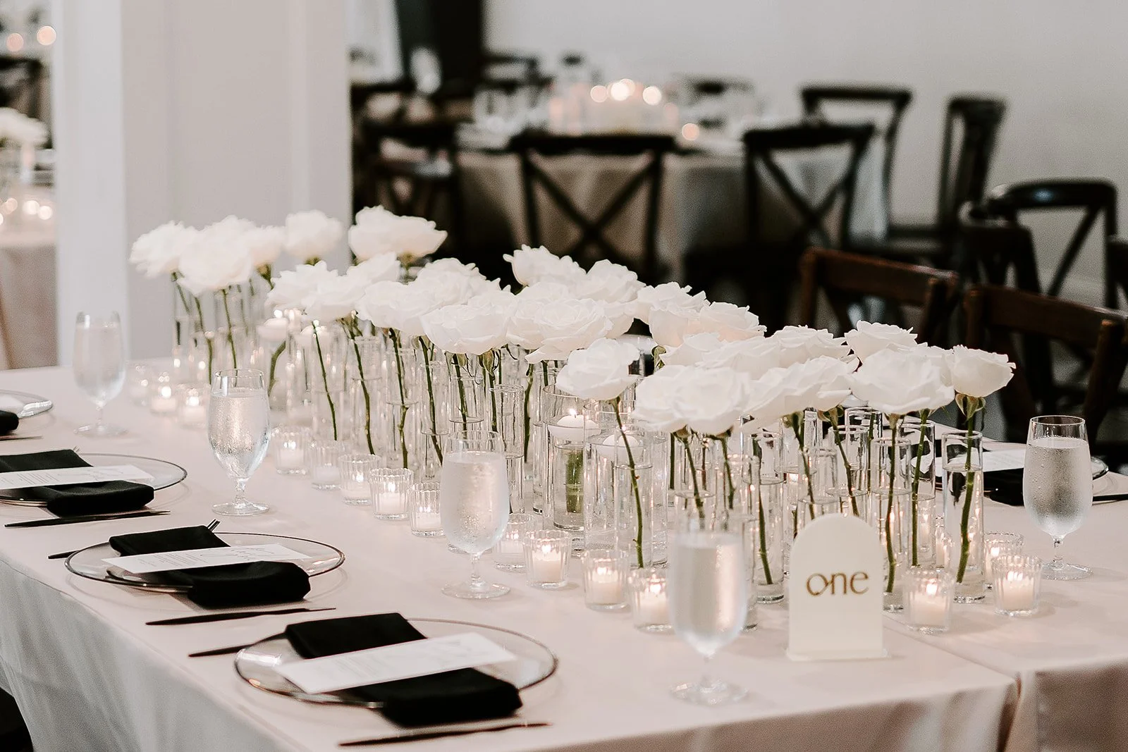 Houston luxury wedding florist designing sophisticated floral arrangements at Luminaire venue with timeless romantic styling.