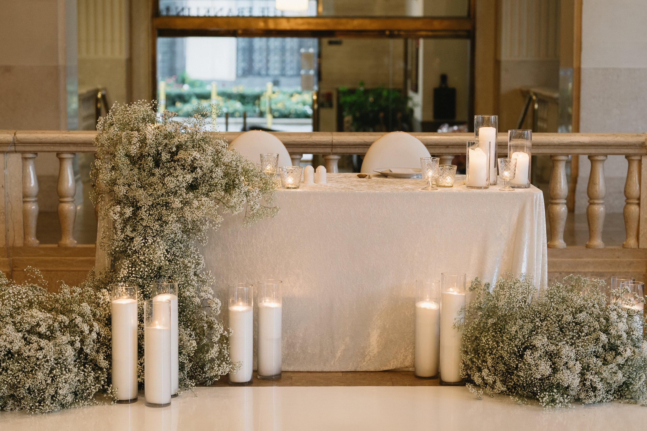 Lush baby's breath sweetheart table floral at The Corinthian Houston wedding reception