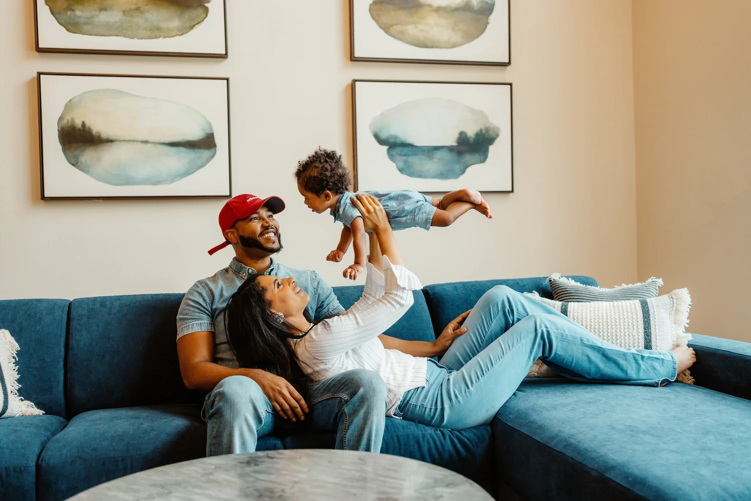 Parents sharing a playful moment with their baby at home