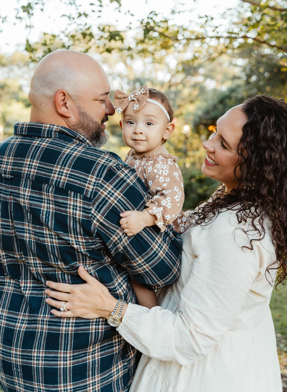 Parents cuddling their baby during a family portrait session