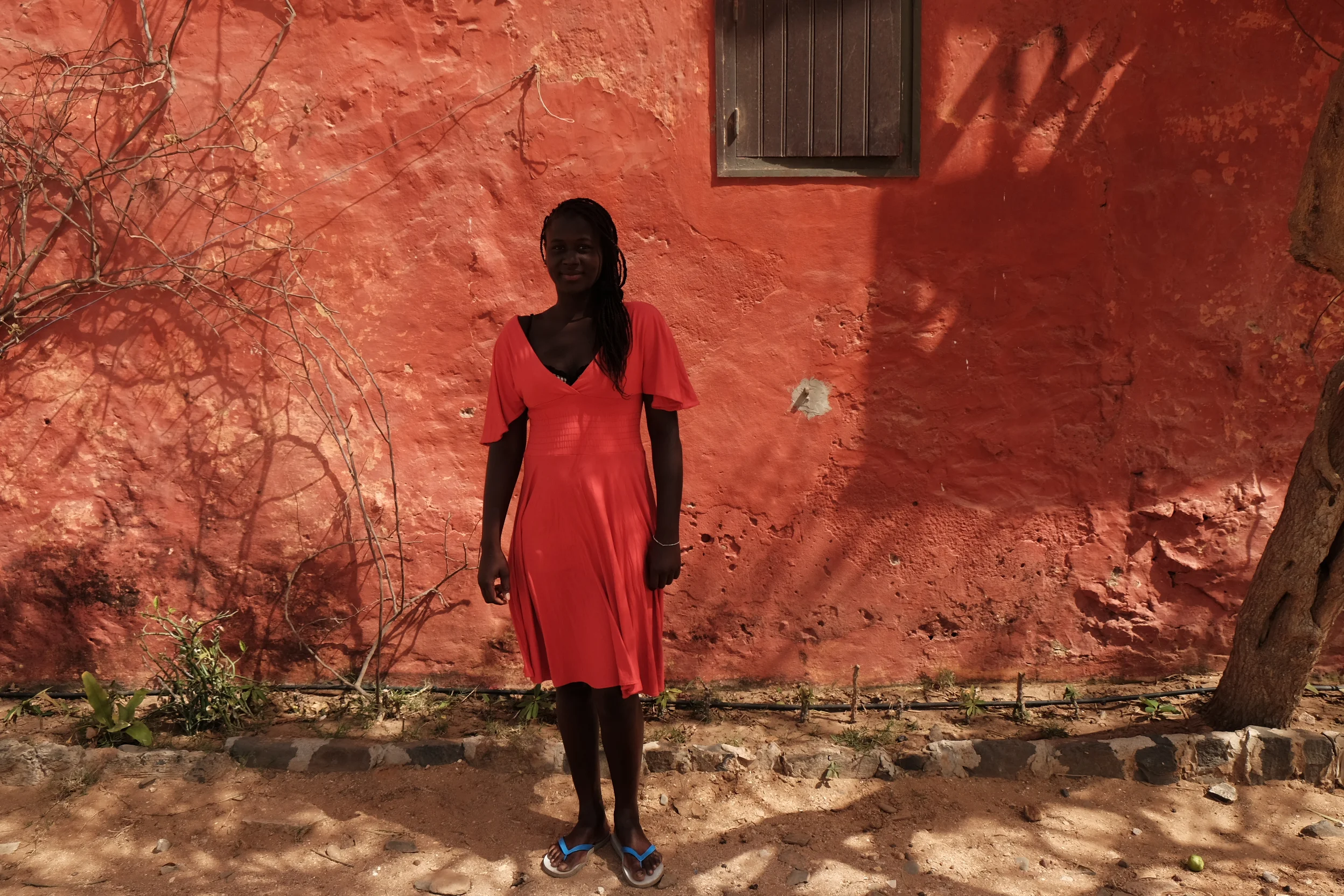  A young girl poses in front of a wall. Goree Island, Senegal. ©2016 