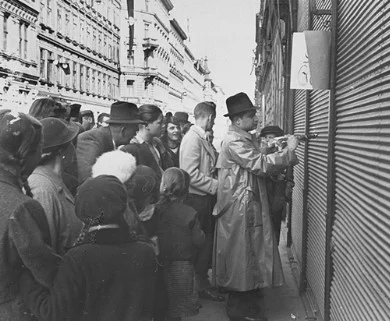 a-jewish-man-forced-to-paint-anti-jewish-graffiti-on-a-shuttered-storefront-vienna-austria-march-1938.jpg