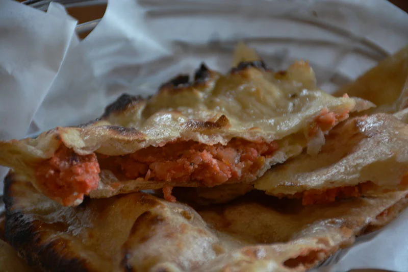 Our murgh tikka pizza is a Tandoori Fusion specialty, made with farm-to-table vegetables and authentic Indian spices.