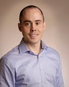 Photo from the waist up of Chris Huff smiling at the camera.