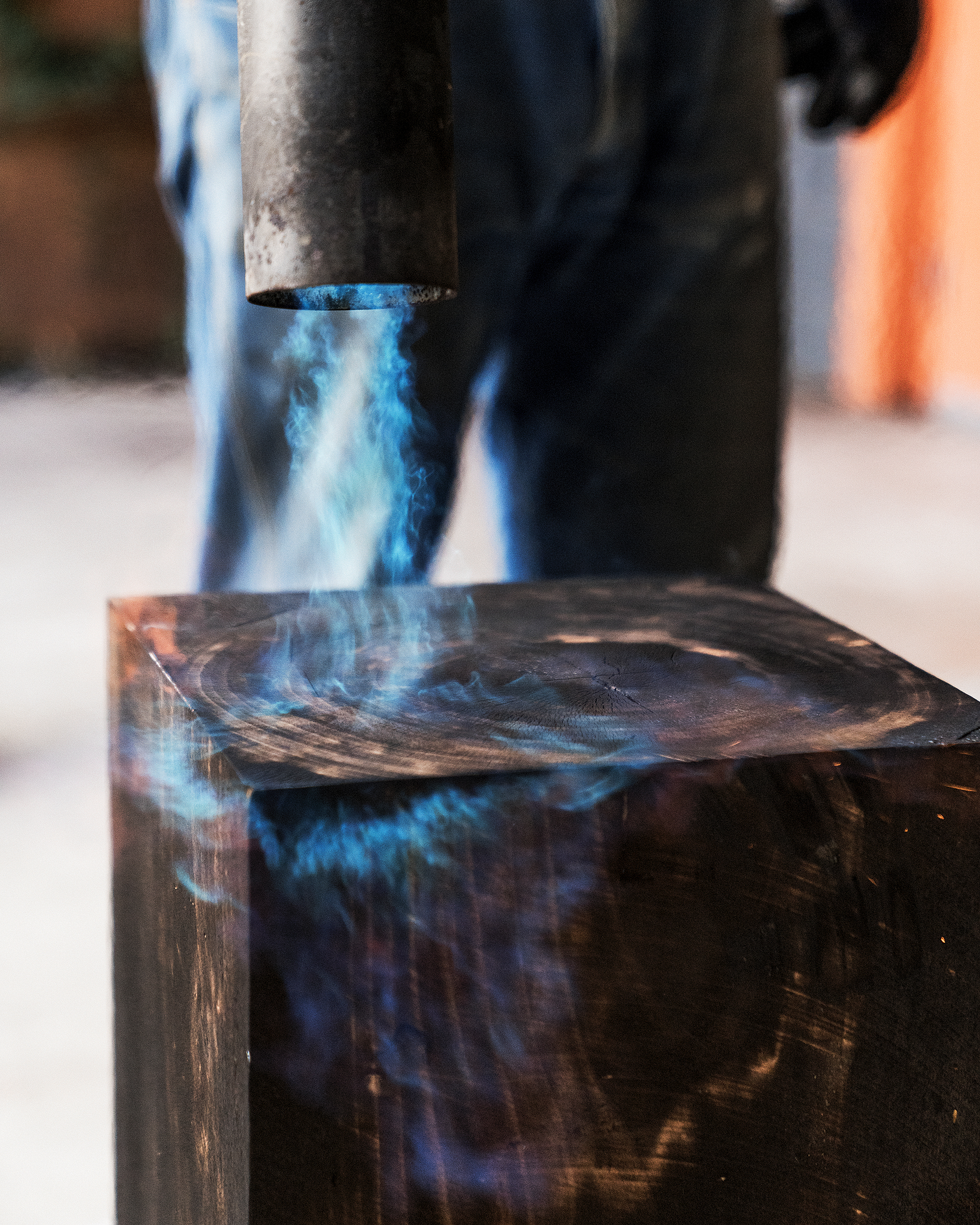 Cliff Spencer burning the surface of a wood stool to create a shou sugi ban finish.