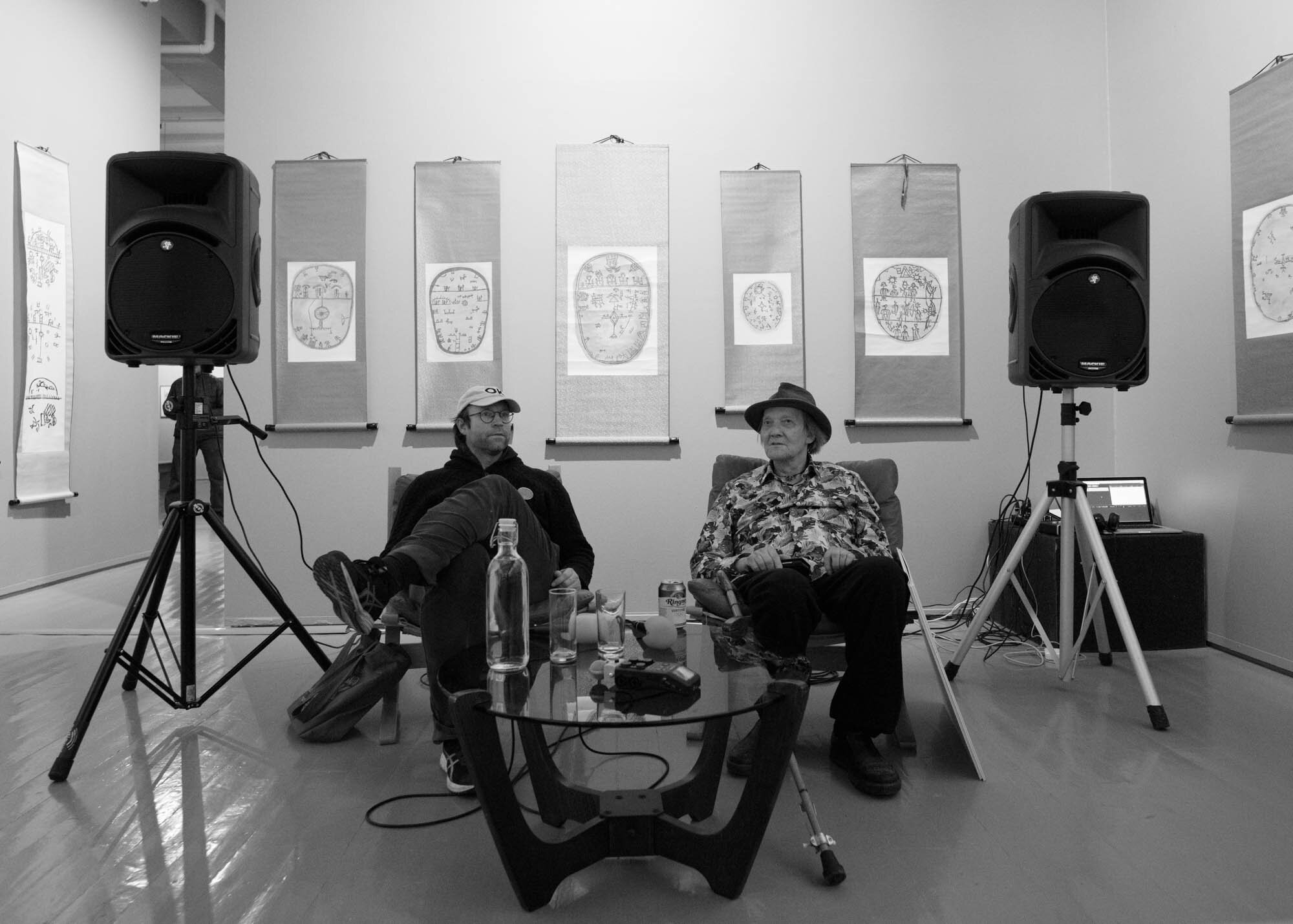  Leif Magne Tangen, director of Tromsø Kunstforening (to the left),  in conversation with artist Elle-Hánsa/Kveiselie/Hans Ragnar Mathisen at Tromsø Kunstforening.   Photo: Mihály Stefanovicz 