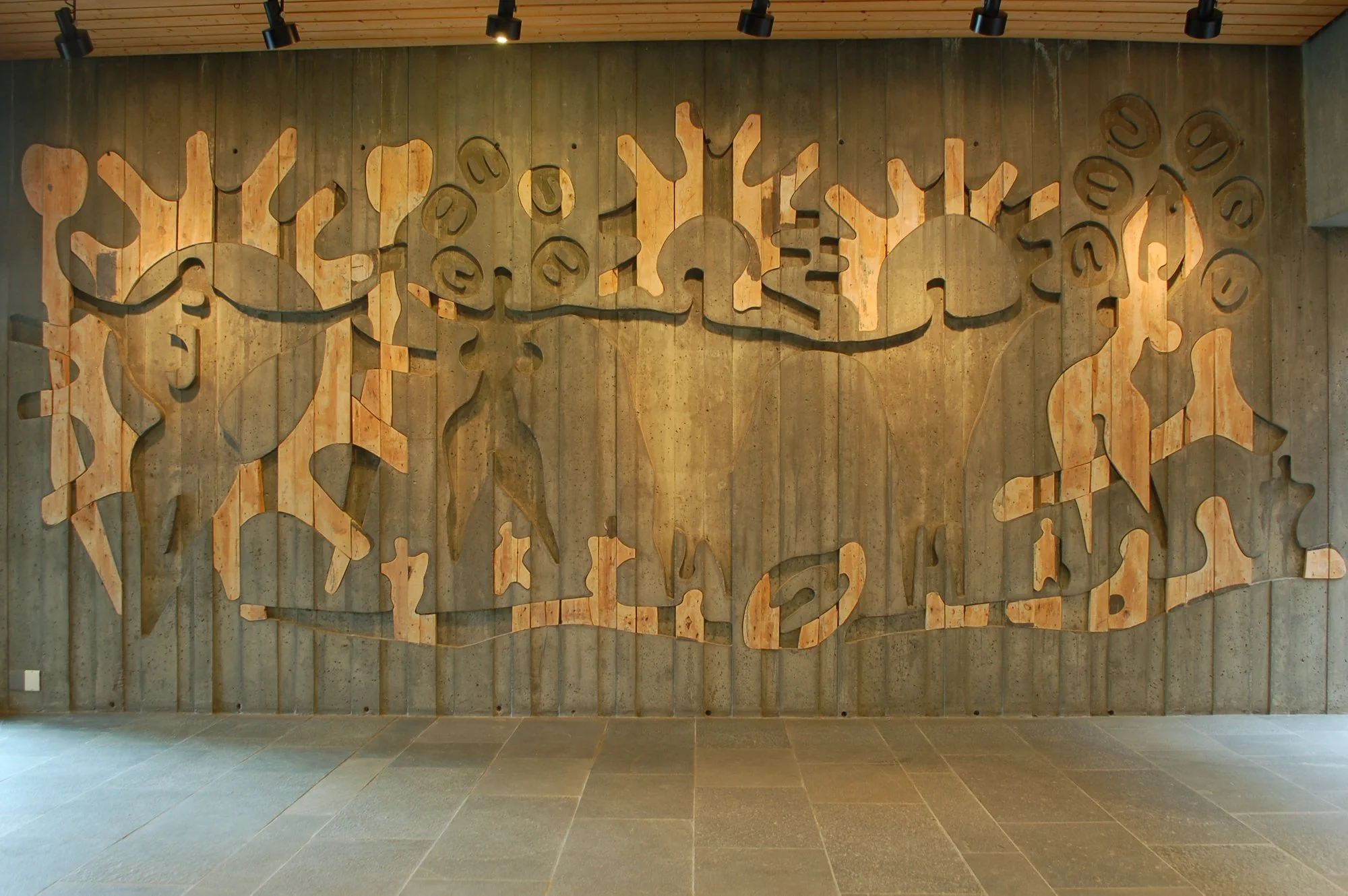 Iver Jåks’ verk  Gudenes dans/Ipmiliid dánsa  (1972) i foajeen til Sámiid Vuorká-Dávvirat/De Samiske Samlinger. Verket er støpt inn i betongveggen. Foto: Elin Haugdal, 2010 