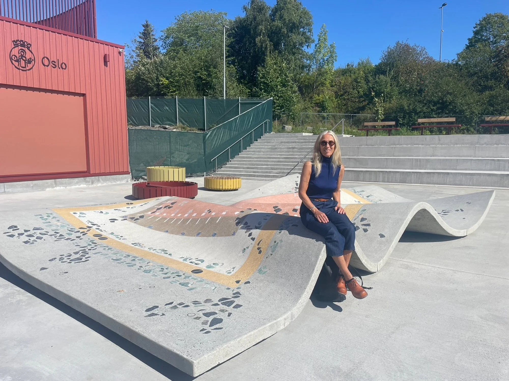   Mellomlanding  (2024)   er et skulpturelt teppe i innfanget betong, med innlagte suvenirer i stein og metall. Foto: Kunstrådgiver Marianne Hall / Oslo kommunes kunstsamling. 