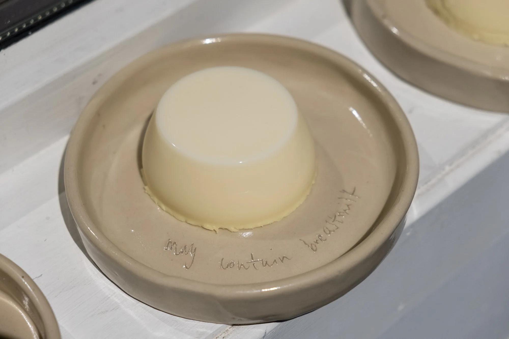   May contain breast milk  (2025), ceramic plates and  Back to work panna cotta  (2025) by soso brafield. Photo: Kurant  