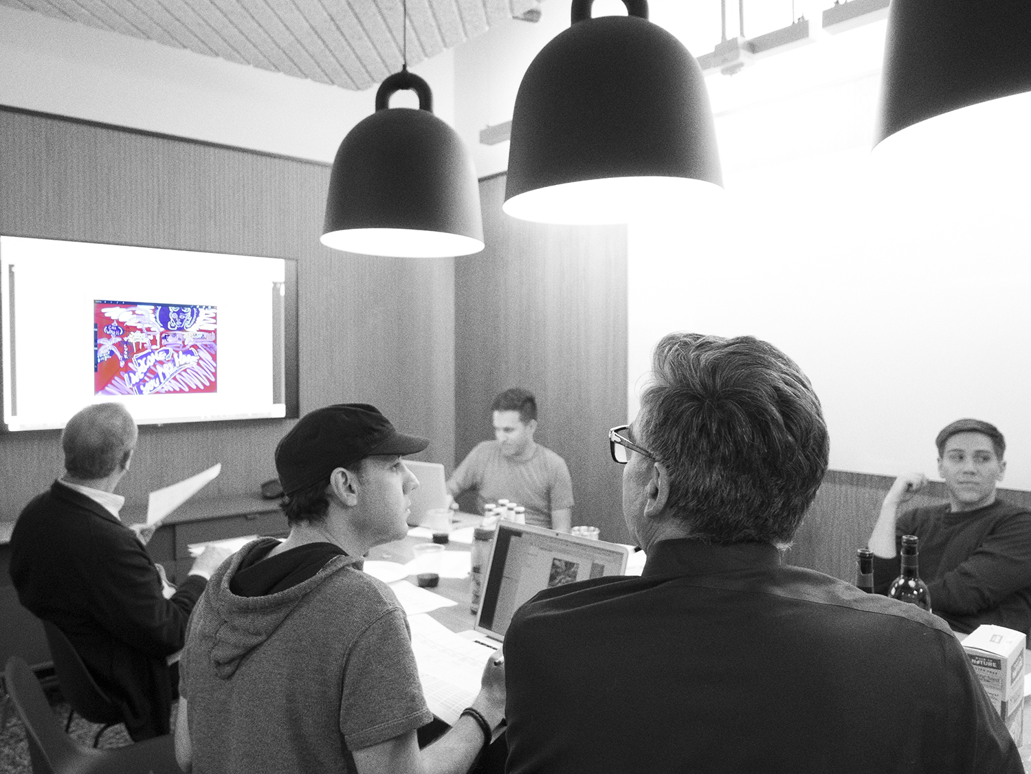 Ric Robertson of Robertson Taylor Partners (left), multi-media artist Omid Orouji (center), Alex Swart, Creative Director/SwartAd (right) evaluate the artists' visualizations.