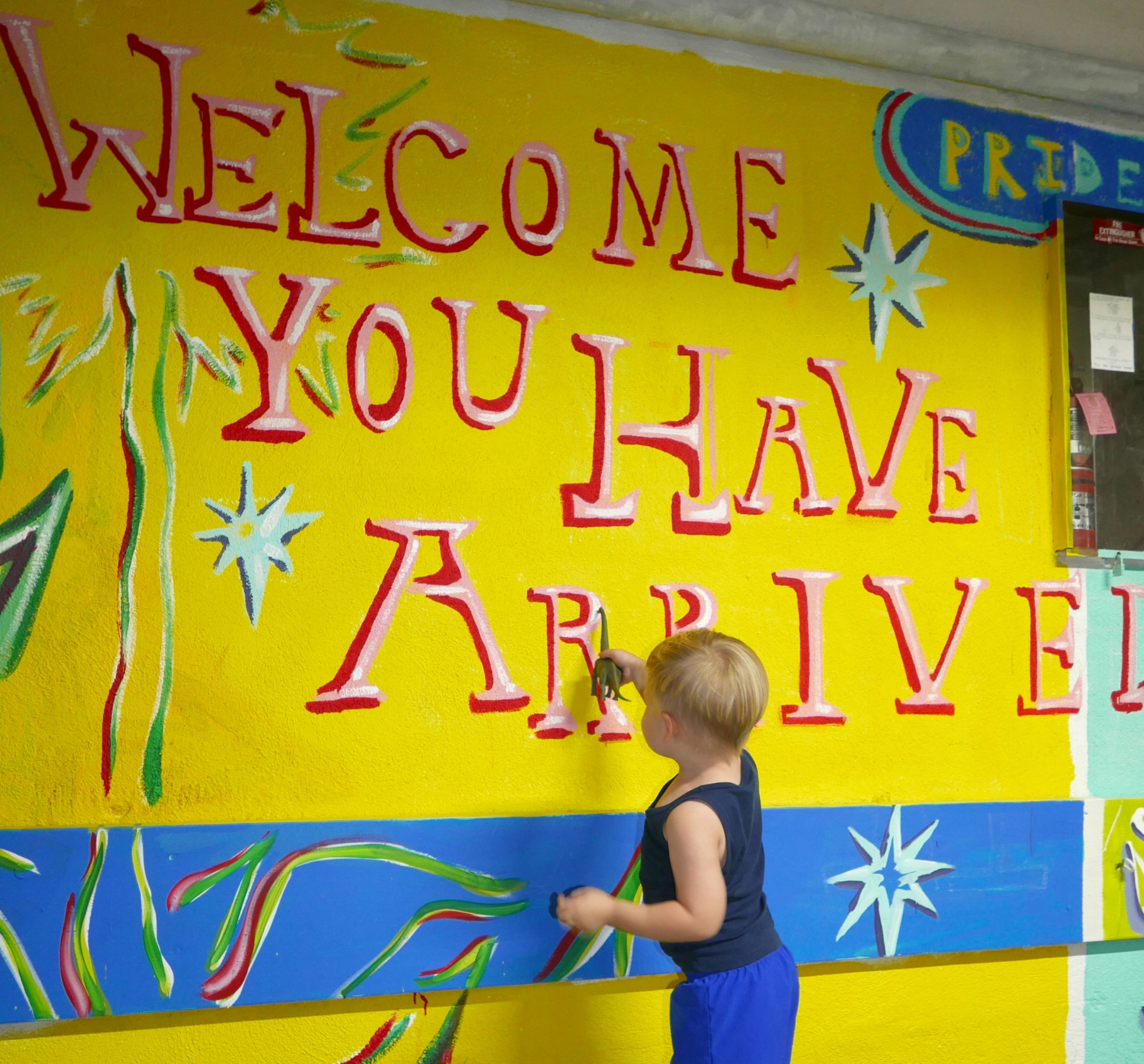 Ben introduces his dinosaur to the mural.