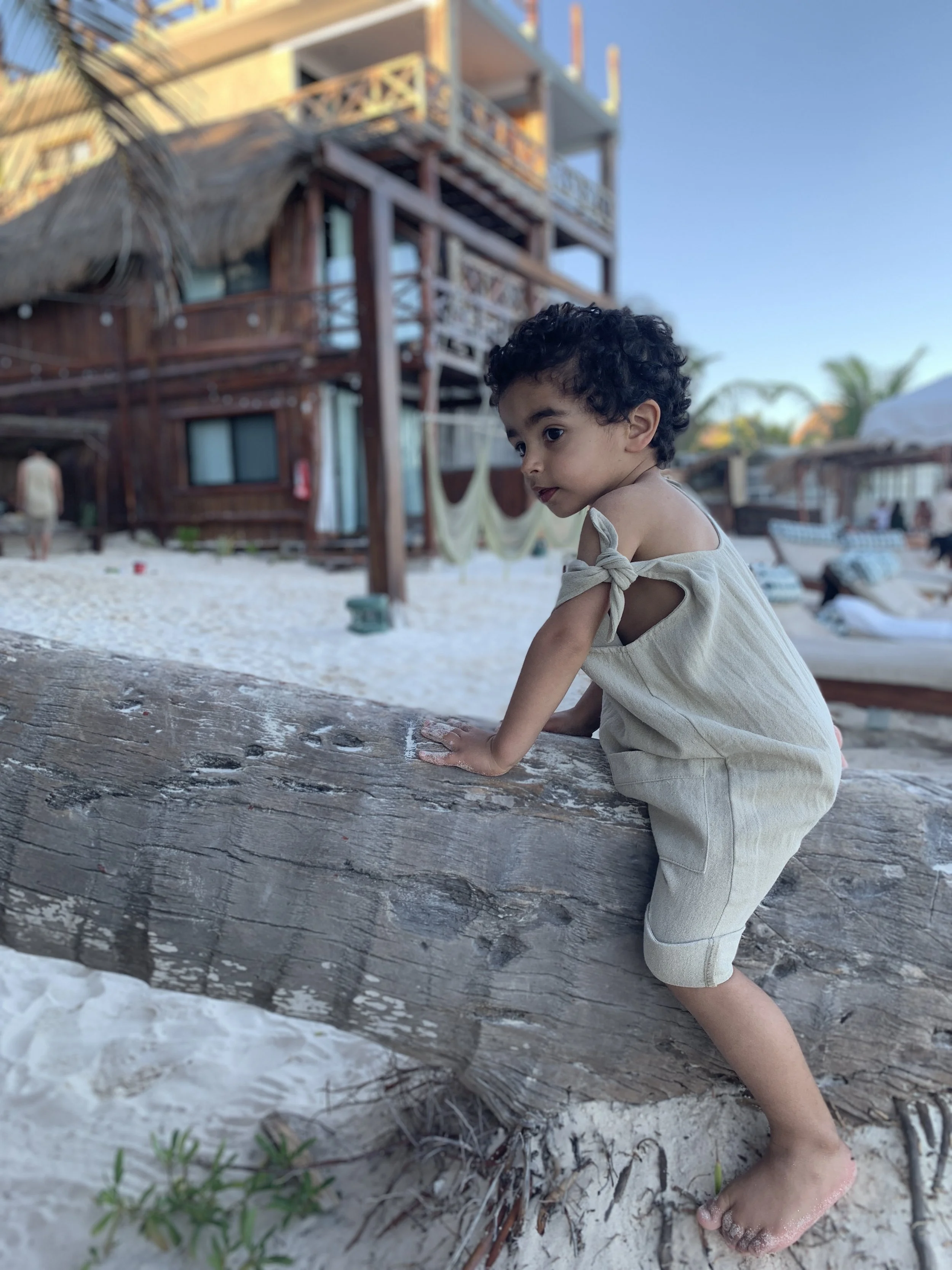 Toddler exploring the beach at a Tulum hotel — English-speaking babysitter in Tulum by Anana Babysitting