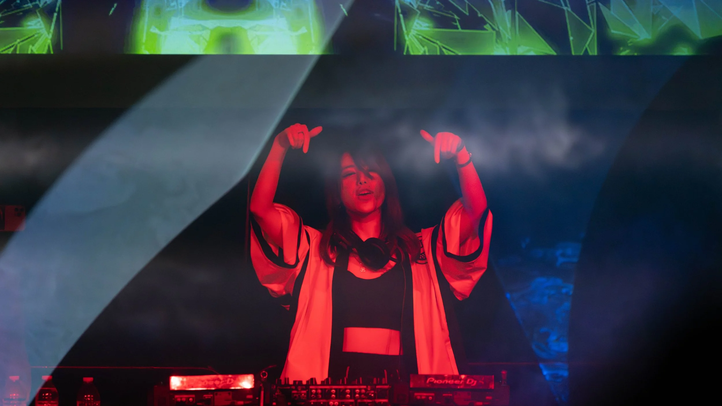 DJ Merlin performs live at Kumoricon in Portland, 2021.
Captured during a high-energy set at one of the Pacific Northwest’s largest anime conventions, DJ Merlin commands the stage with immersive lighting and a packed crowd. This photograph documents 