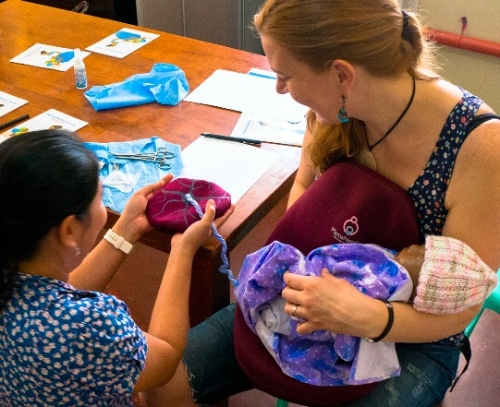Diploma program instructor Rose teaching Helping Mothers Survive Bleeding After Birth to midwives in Asia, using the MamaNatalie birth simulator. Mercy In Action trains midwives as trainers, then they use the life-saving knowledge in clinical practice AND pass it on in future trainings to untold numbers of birth workers.