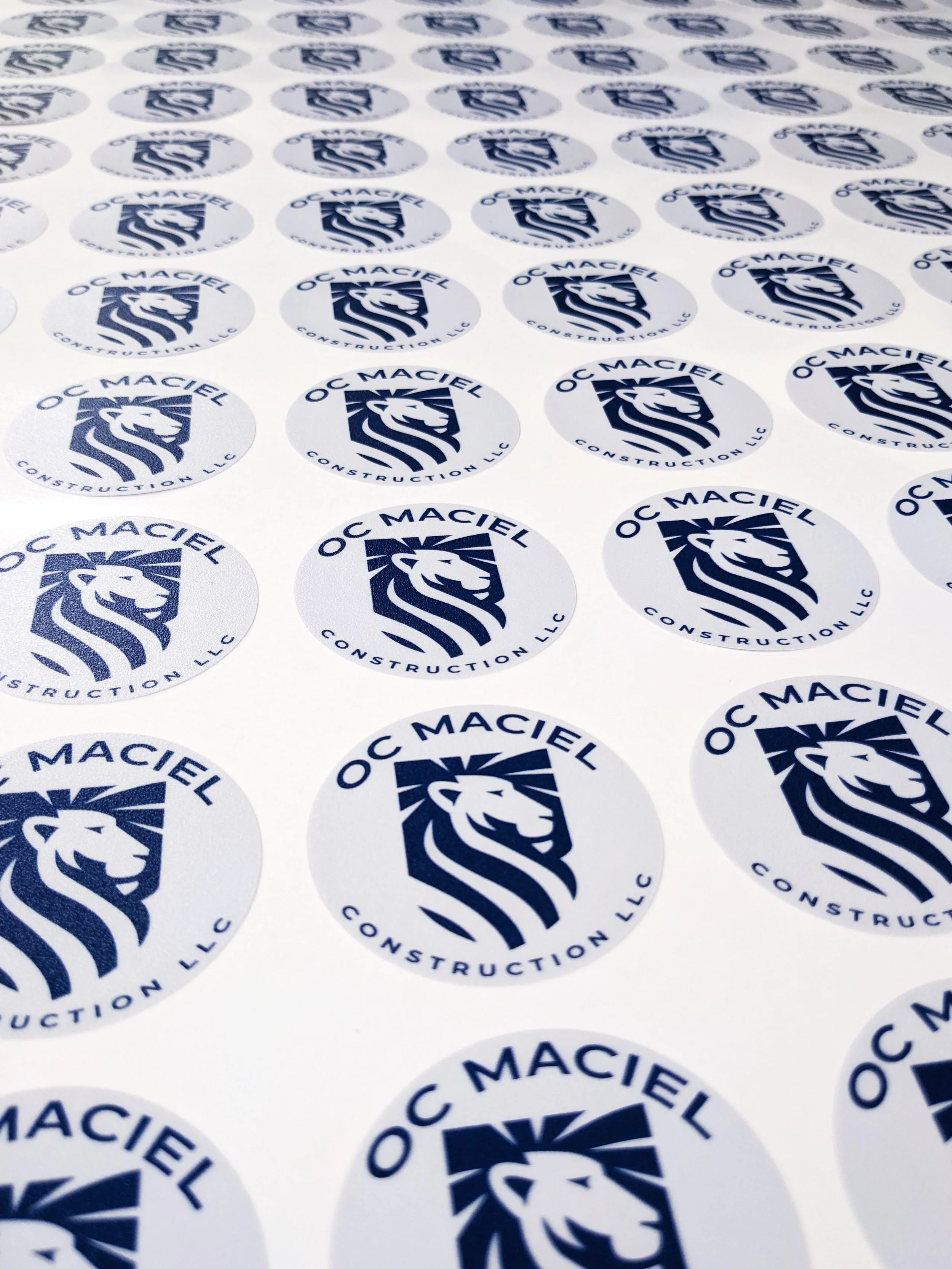  A sheet of custom circular brand logo stickers on weatherproof adhesive vinyl. 