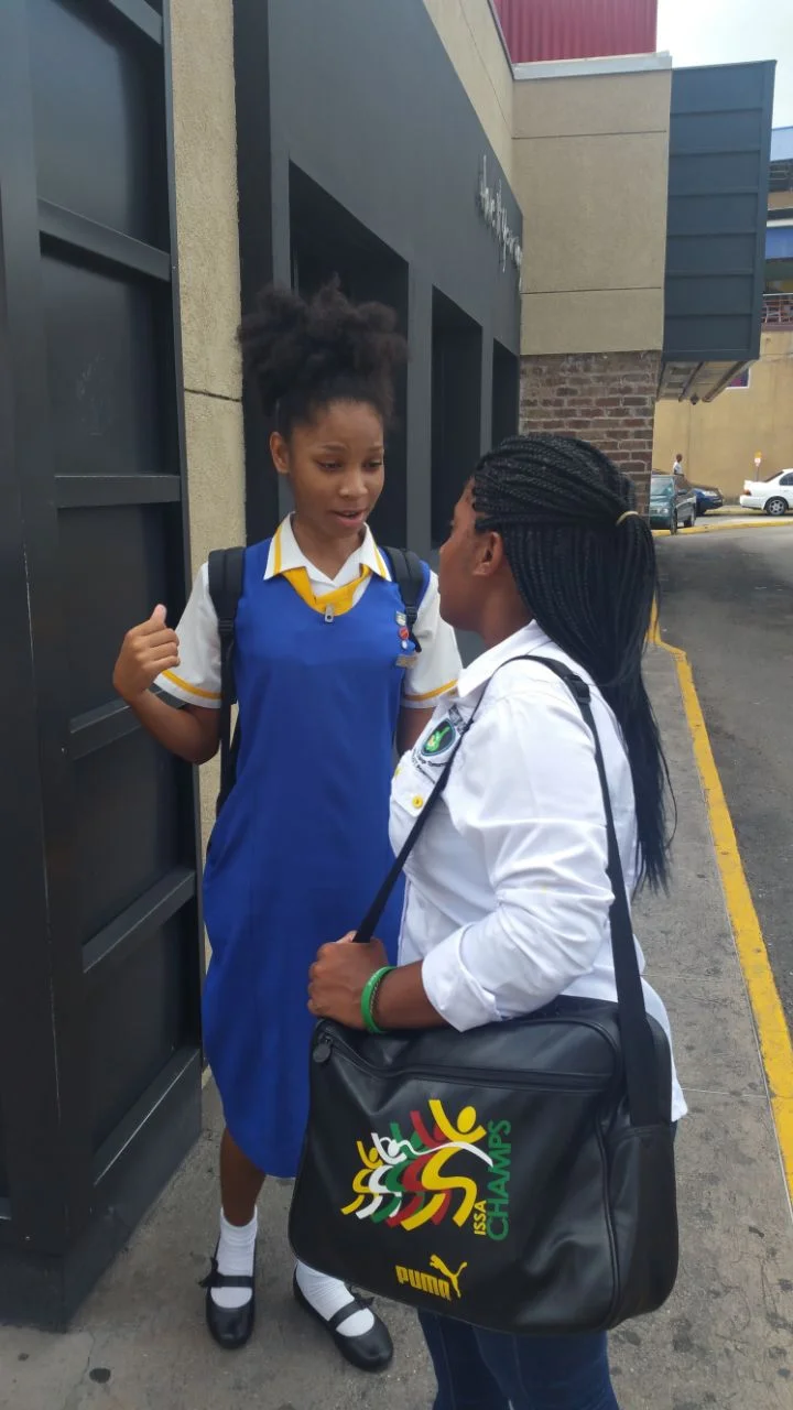 Tianna Thompson interacts with President of Youths Inspiring Positive Change Ja Samantha Miller