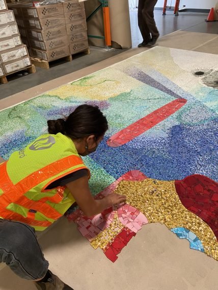 Metro Art staff carefully laying out one of over 750 sheets of glass mosaic during dry-fit.