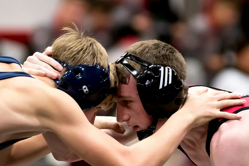 The beginning of matches is normally fairly slow with respect to action. There are a lot of collar ties, and a lot of hand fighting, trying to set up a shot. It is nice to be able to zoom in tight with my 80-200mm f/2.8 to get some of the expressions on the wrestlers faces. Settings: 200mm, f/2.8, 1/500 sec, 5000 ISO