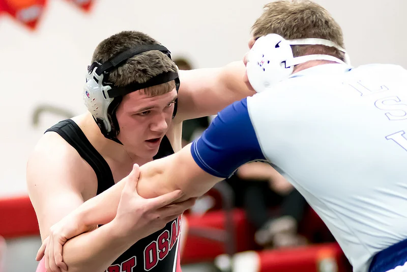 The heavier weight classes are the worst at slow action. In most cases it is a lot of hand fighting and collar ties. In this case however, the Fort Osage wrestler set up perfectly his takedown and eventually pinned his opponent. Settings: 135mm, f/2.8, 1/500 sec, 8000 ISO