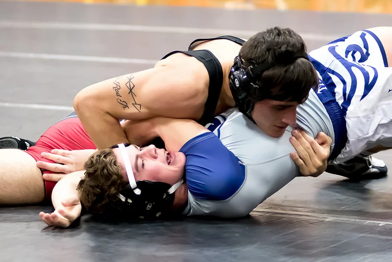 Of course, there is nothing more exciting than a pin. Sadly, since they wrestle in a circle, its hard to be in the right position, and have them looking towards you when it happens. Sometimes I get lucky though. This was the best pin shot that I got all night. Settings: 86mm, f/2.8, 1/500 sec, 8000 ISO