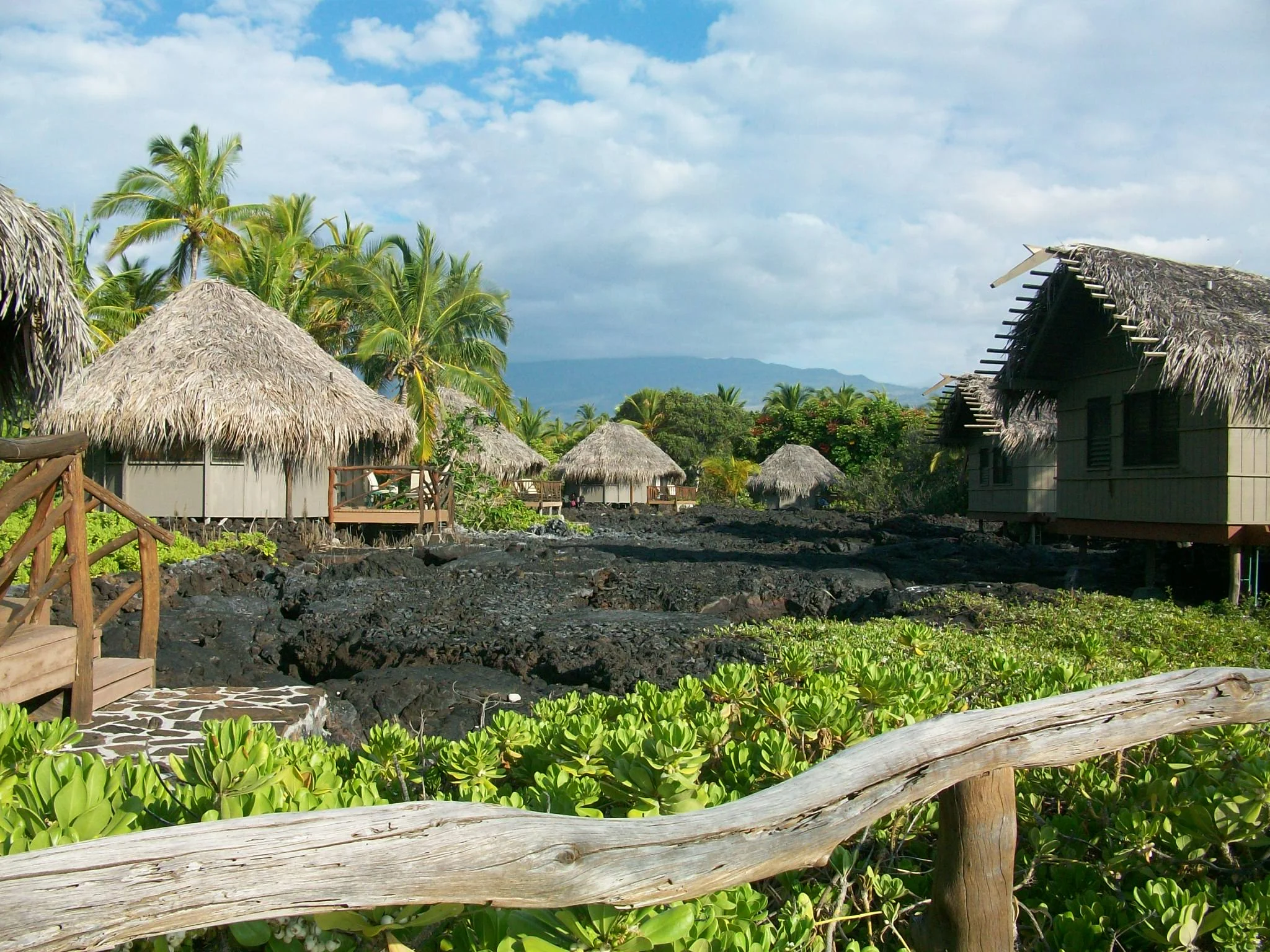 A shot of the Hales lined up on the lava flow, with a volcano in the background.
