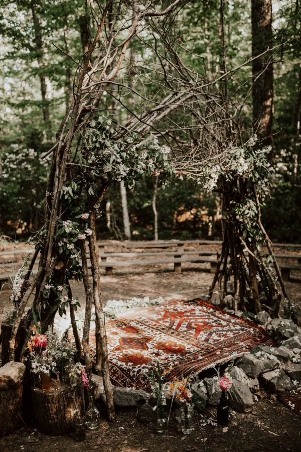 A stunning wedding tipi from branches and greenery found on June Bug Weddings .
