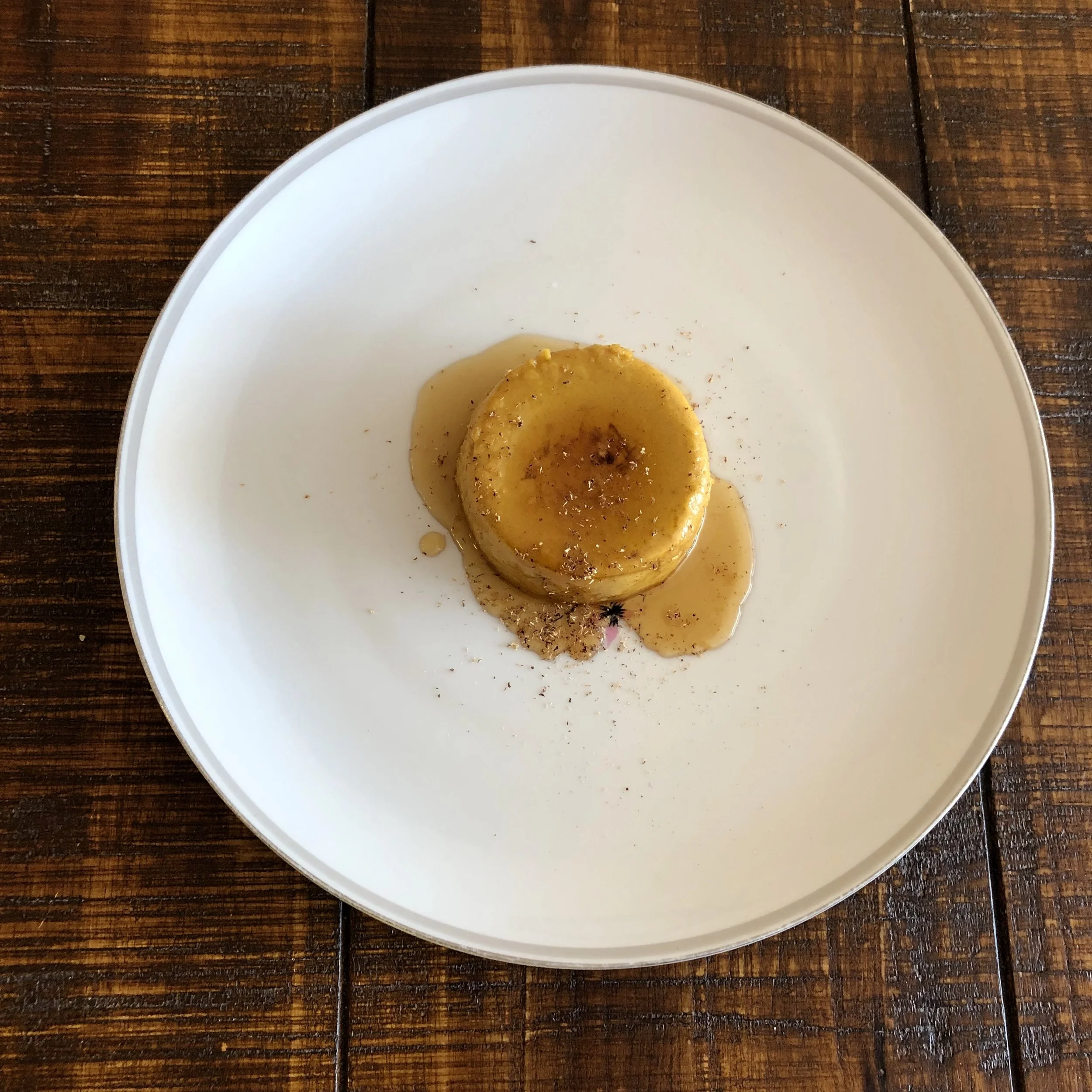 Optional: With a knife, loosen edges of custard and invert ramekin onto a plate. Serve with additional maple syrup and a dusting of freshly grated nutmeg.