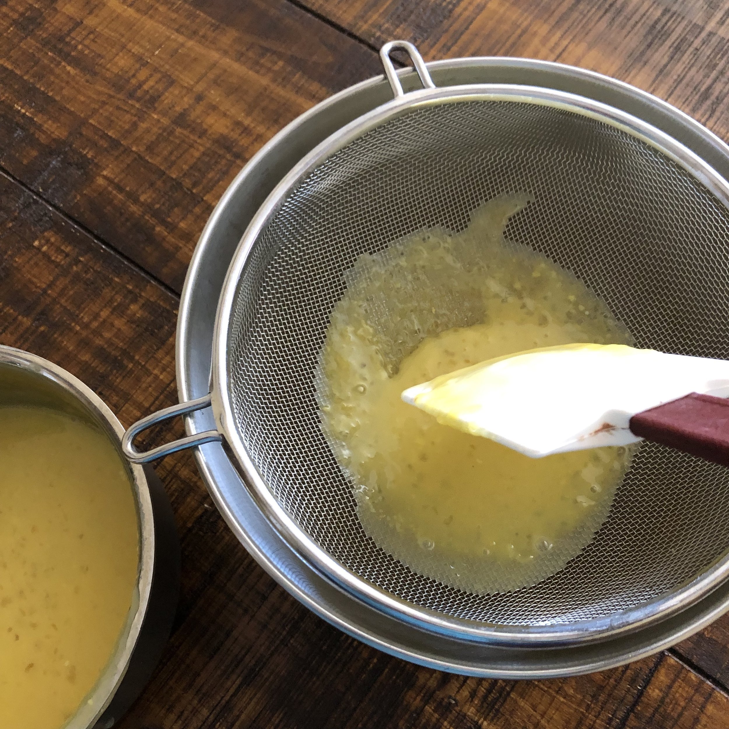  Strain the liquid through a mess strainer to remove any tapioca lumps, eggs bits, and large pieces of lemon zest. Use a rubber spatula to gently press it through. 