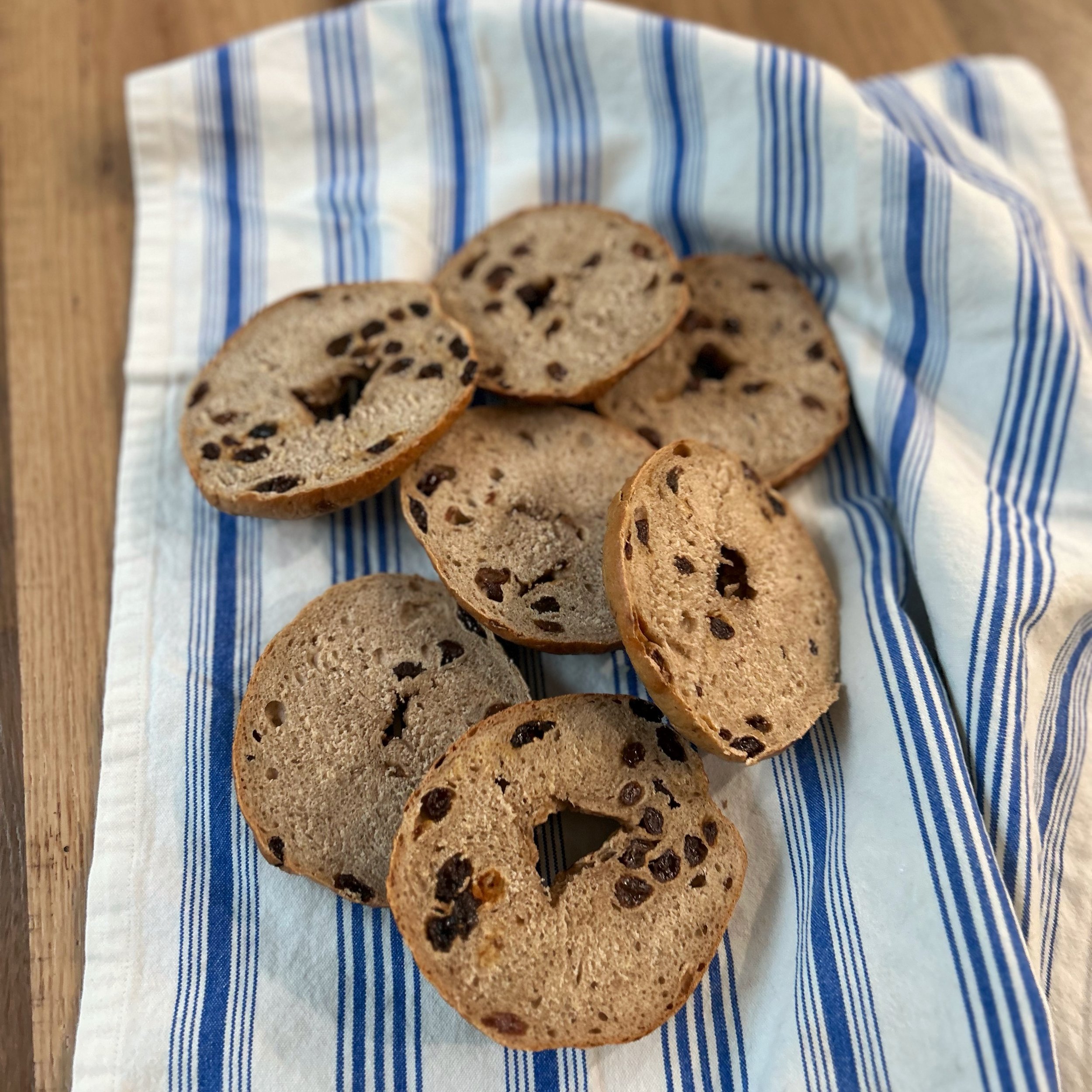 cinnamon raisin bagels on blue towel.jpeg