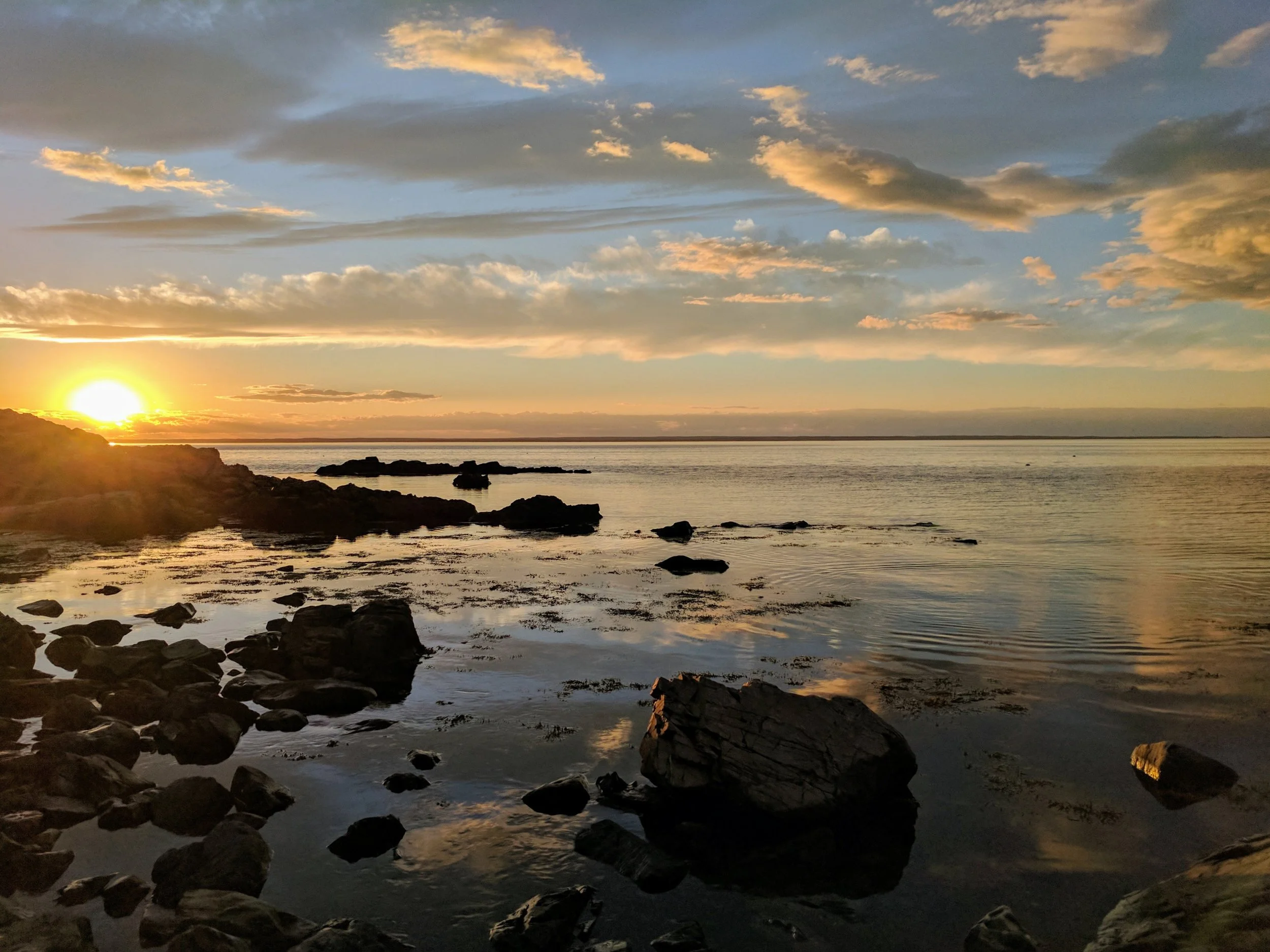 sunset-over-water-by-rocky-shore_4460x4460.jpg