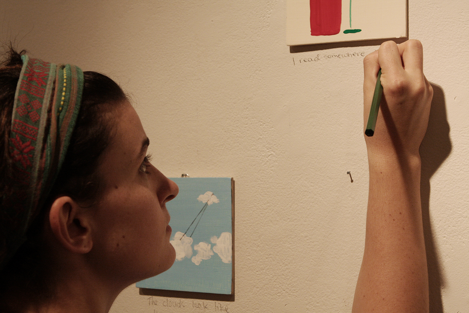   Today speak only in pictures , 2013, participant writing her submitted words under her painting 