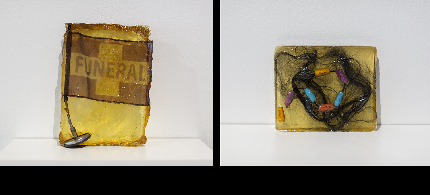   Alisha B. Wormsley  Left:  Funeral (There Are Black People in The Future) , 2015, funeral flag, ink, resin; Audio Composition by Ricardo iamuuri Robinson, 1min 05sec. Right:  Hair (There Are Black People in The Future) , 2015, hair, beads, ink, res