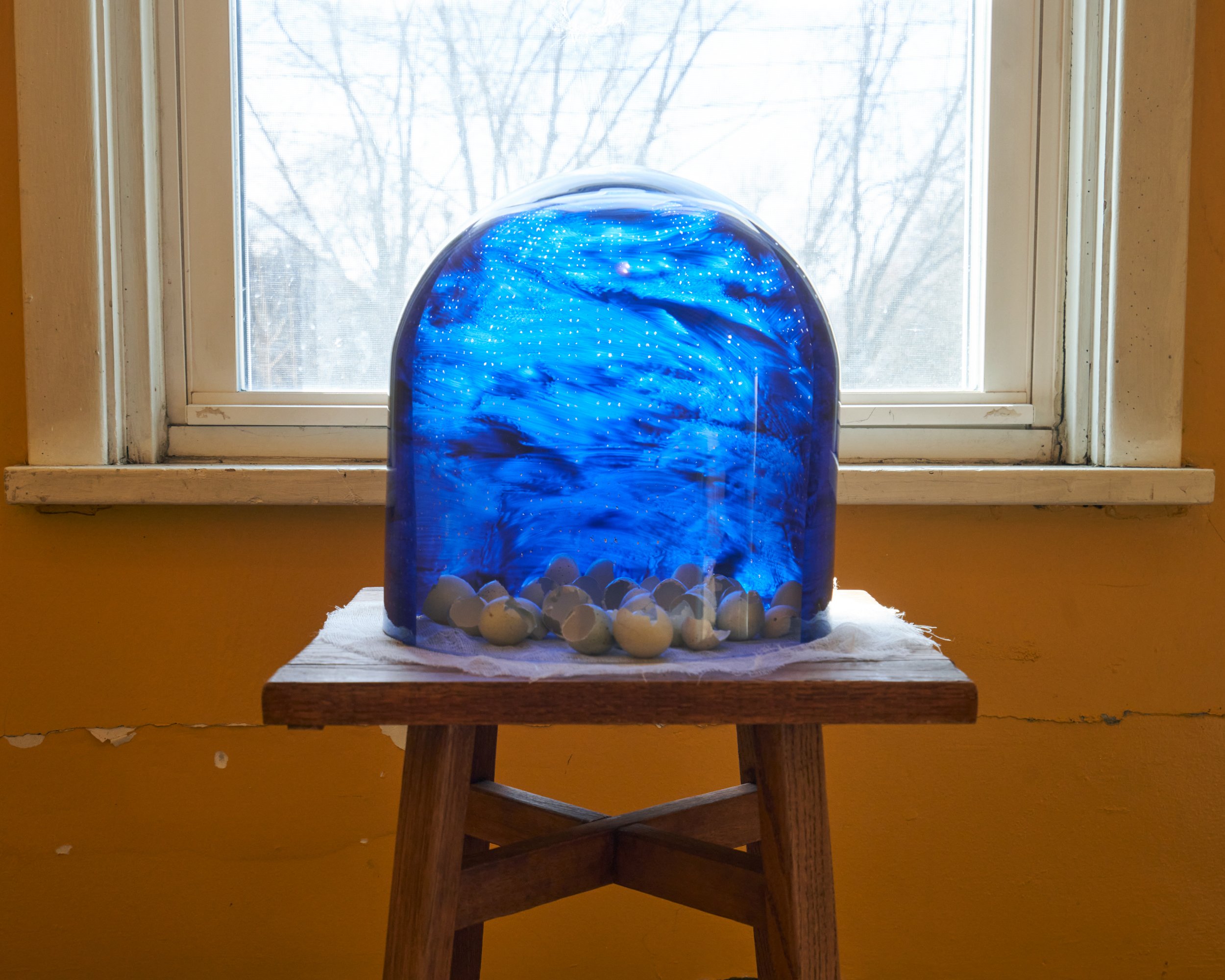  detail of  The clerk's wife claims her name, and her own night sky.  2021-2023. Acrylic paint on glass dome, celadon quail eggs, cheesecloth.  34 x 12 x 13 inches. 