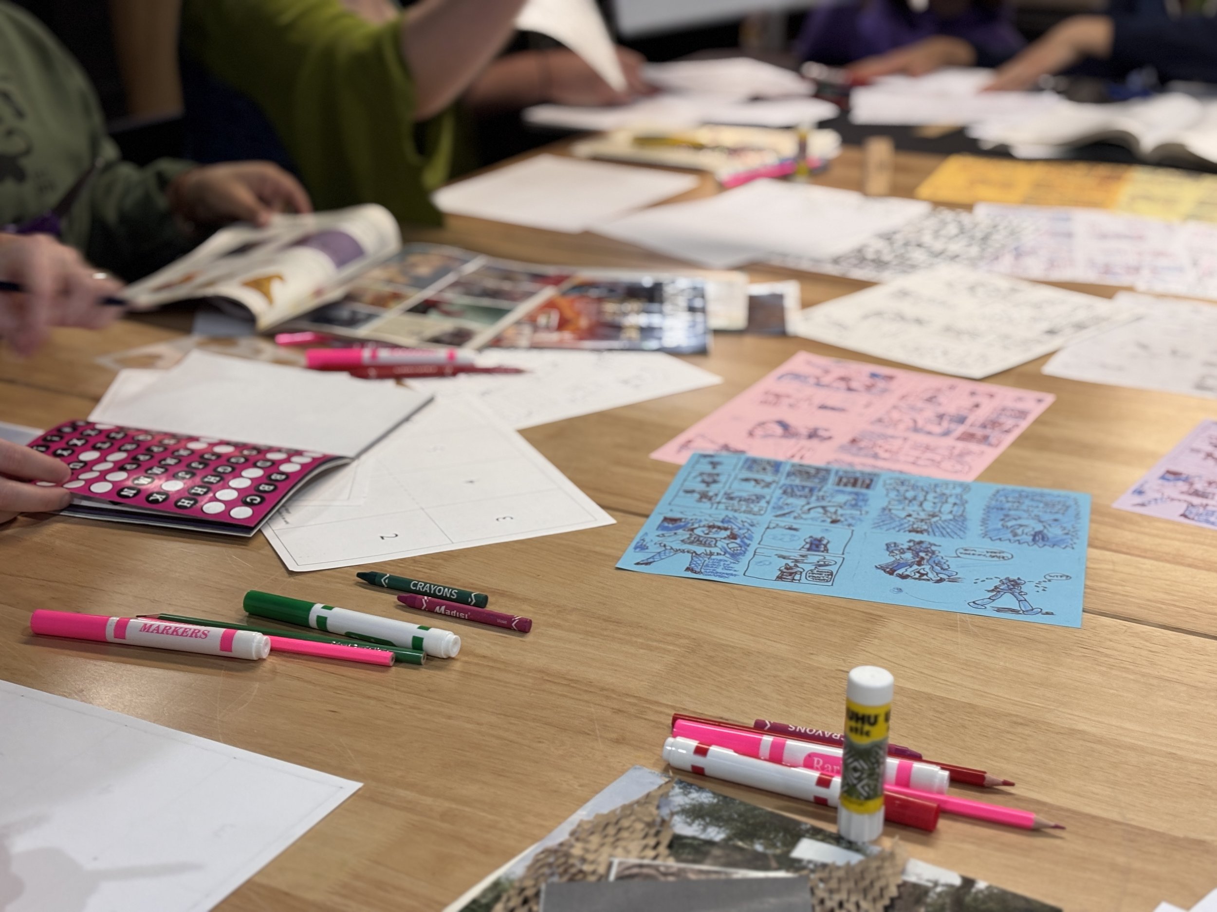 Collage and drawing materials on a table ready for riso printing