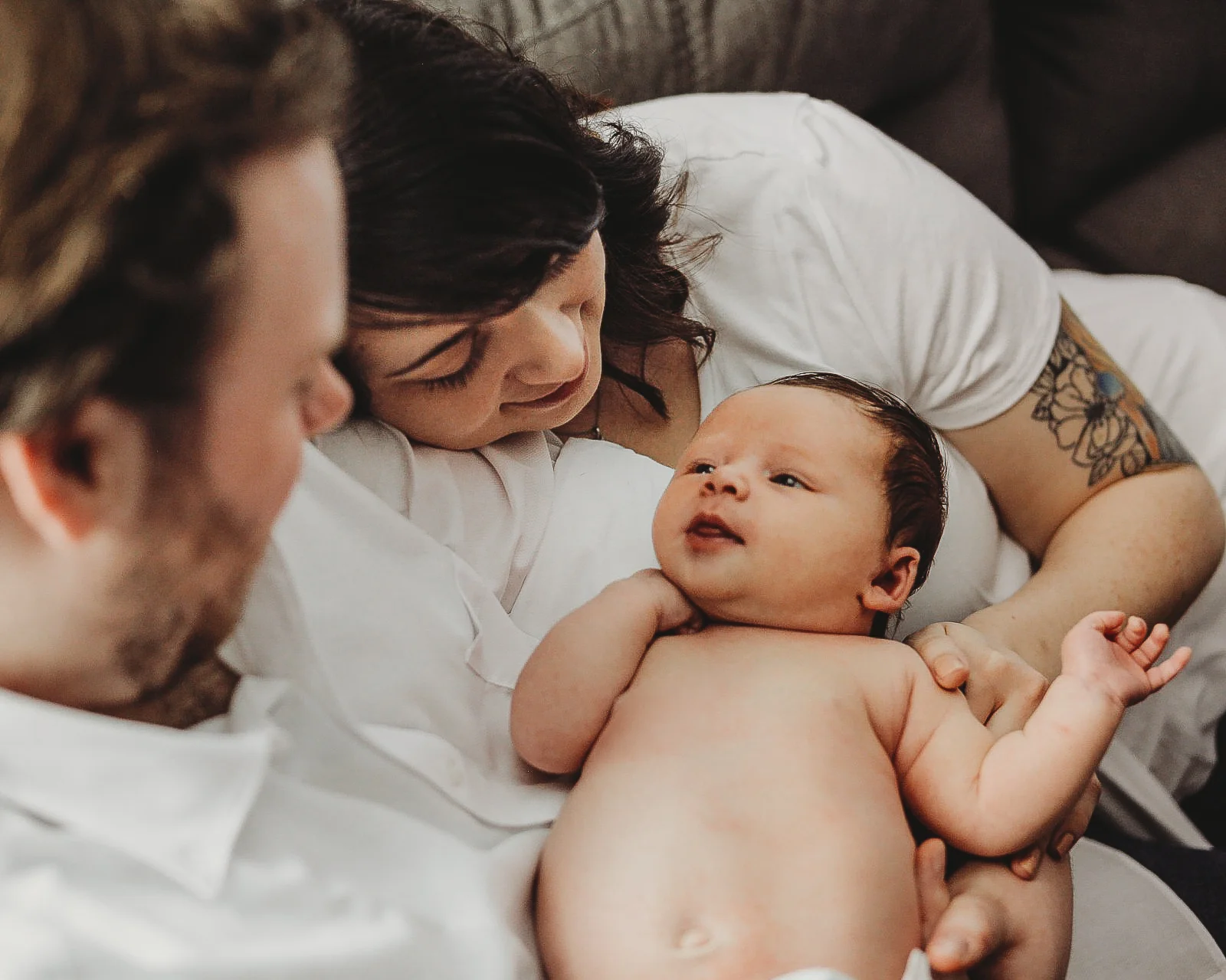 In Home couch cuddle with mom  dad and baby