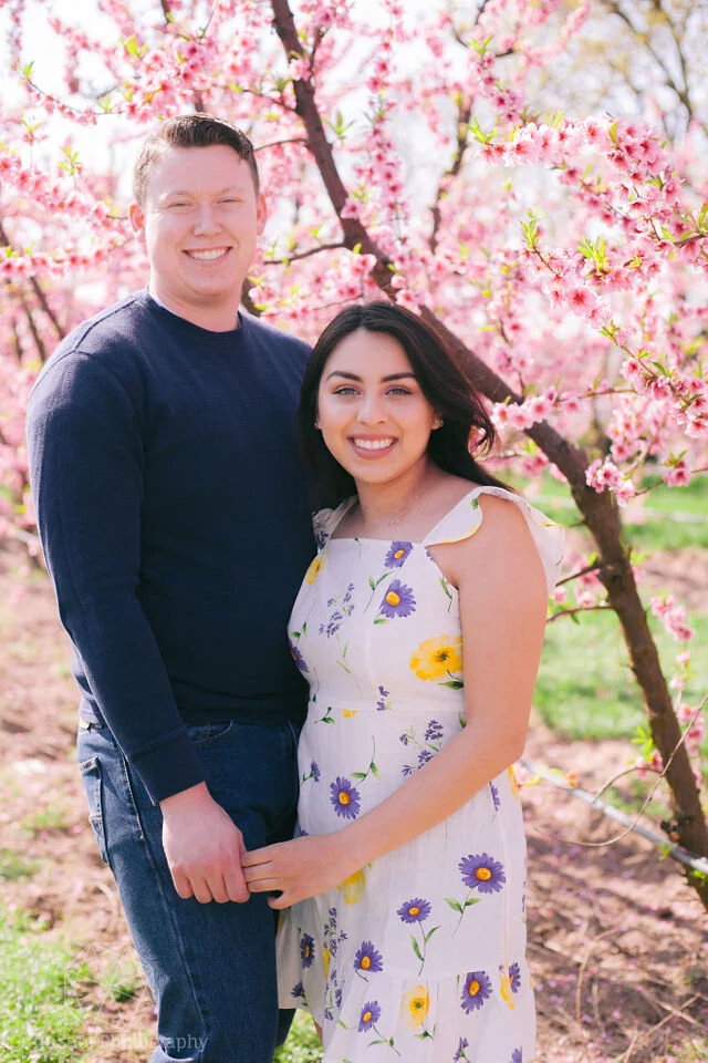 Man and woman hold hands in blossom trail