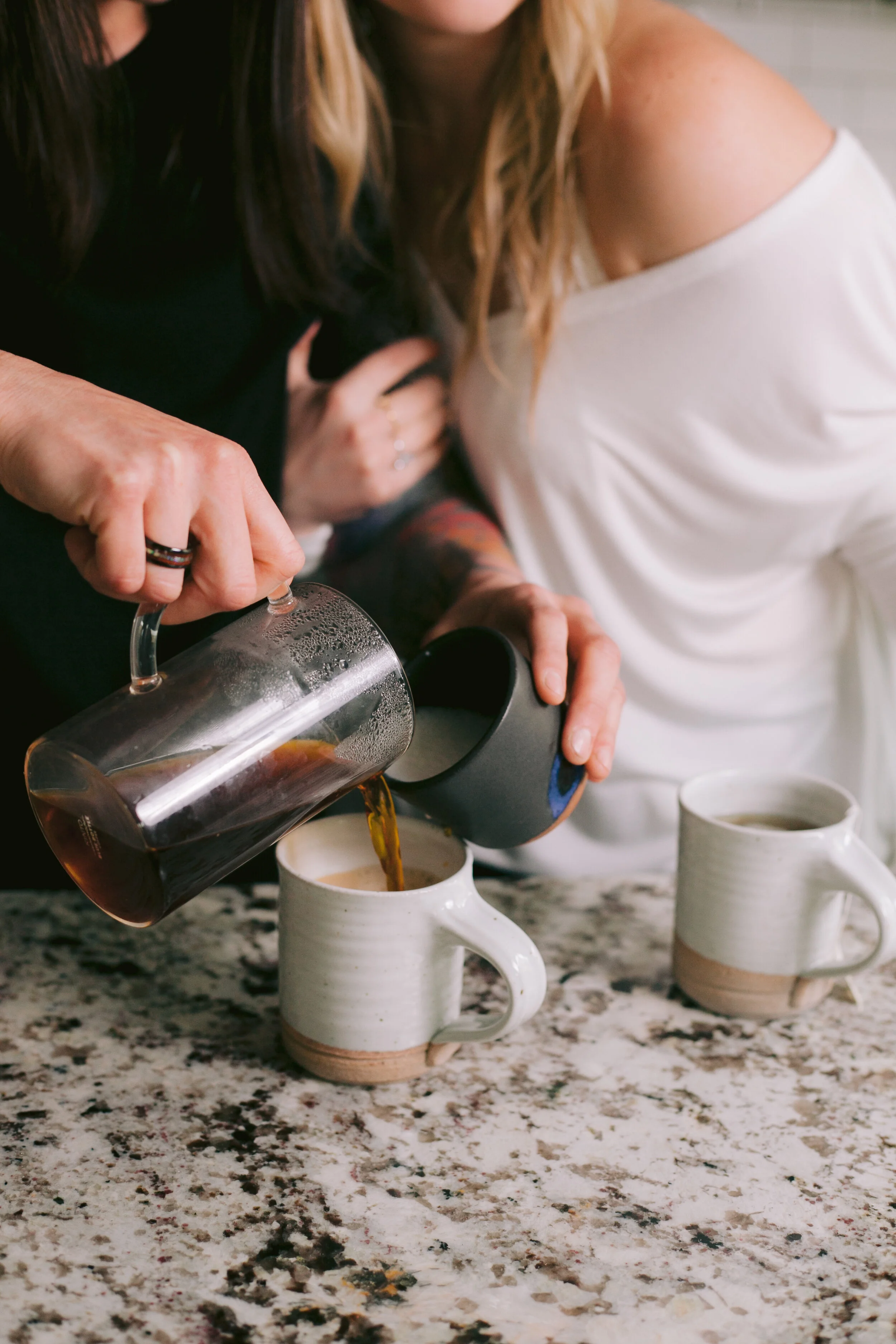 Couple pours coffee in the kitchen