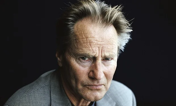 I think of it as inexplicable sadness, although the explanation is actually pretty clear. It’s a distant sorrow, though, mourning a life that I have little connection to and even less actual contact with. Sam Shepard has died, best known as an actor but cherished as a playwright, a dark, brooding, subversive voice that broke through the landscape of Mamet and Rabe and the rest of the 1970s theater world. His seminal (or breakout, I suppose) play was Buried Child , a fractured family drama that suggested fault lines in the domestic stories we tell ourselves. Something wicked isn’t coming our way; it’s buried in the backyard, he said, and we buried it ourselves, a long time ago. Buried Child was first produced in the summer of 1978; two years later, I was in a summer repertory production of it, appreciating having the lead but frustrated by playing someone half a century ahead in life, with gray wigs and latex wrinkles. Not to mention doing the little dance we all had to do around our star power, actress Mercedes McCambridge (who played my wife, if you can imagine. Or maybe don’t imagine). Another year would go by before I wrote my first play, influenced by Shepard but knowing the similarities ended with writing words for actors to say. His vision was alien to mine, richer and darker than anything I could create. I had little use for the others, to be honest, never jumping on those bandwagons with their metered vernacular, heavy on the profanity and light on the profound. This wasn’t the case with Sam Shepard, and if I couldn’t emulate it I could at least admire. There was a lot to admire, and not just his writing: he owned the screen when he appeared in films, his tendency toward less always ending up more. I’d never compete there, either. I didn’t know he had ALS. I didn’t know much about his life in recent years, aside from an occasional reboot of his canon, or a surprising role in a film I wandered across while searching for something else. That feels appropriate somehow, since Sam Shepard always struck me as a searcher, a seeker of something over the horizon and possibly only found in the past. He was almost a silhouette of the past, in fact, at the same time jarringly contemporary and a throwback to an earlier American man, leathery, lanky, solitary. Sorrowful. Dammit.